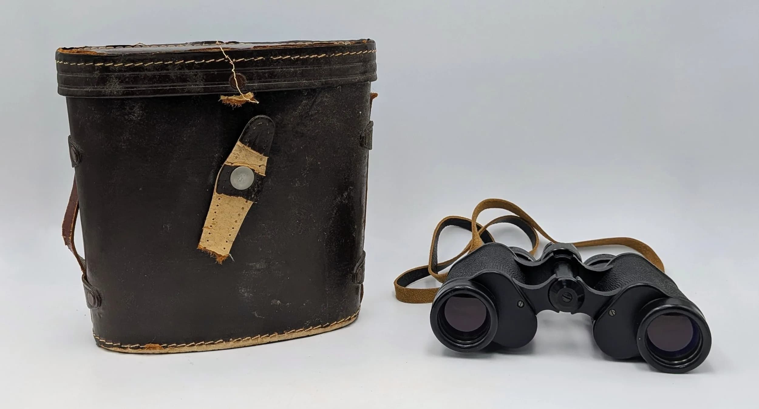 A Pair of USSR BPC4 8x30 Binoculars. Made in USSR, presented in a fitted brown leather case with red interior. Case is damaged.