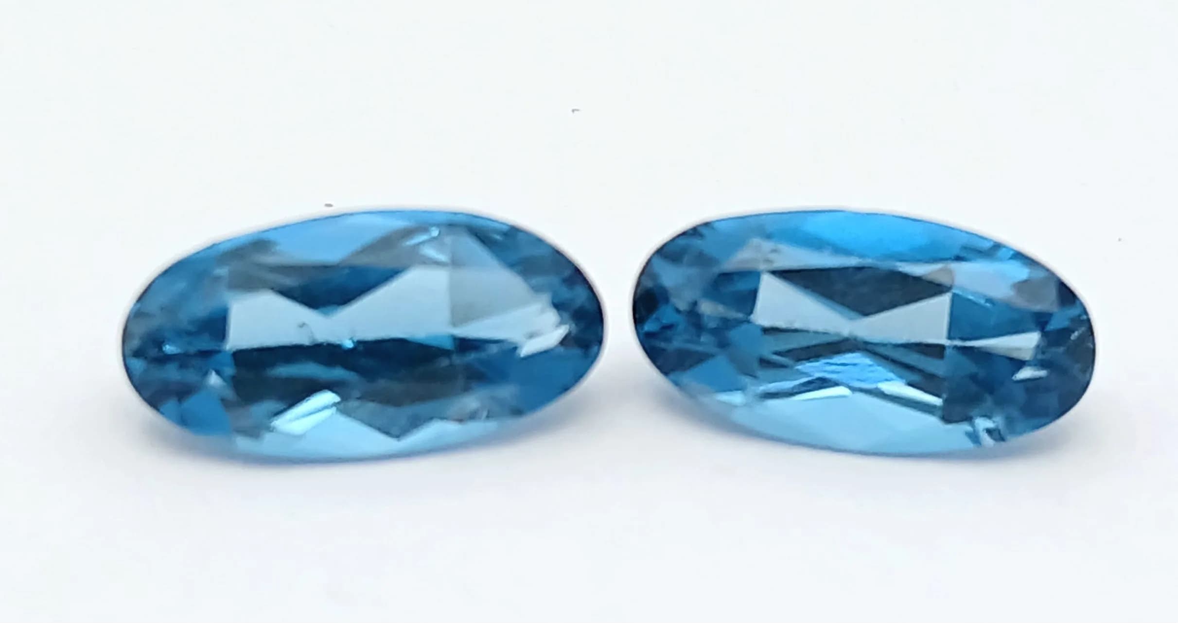 A Pair Of, London Blue Topaz, Elongated Oval Cut Stones. 5.55Ctw. Mgb N/A1