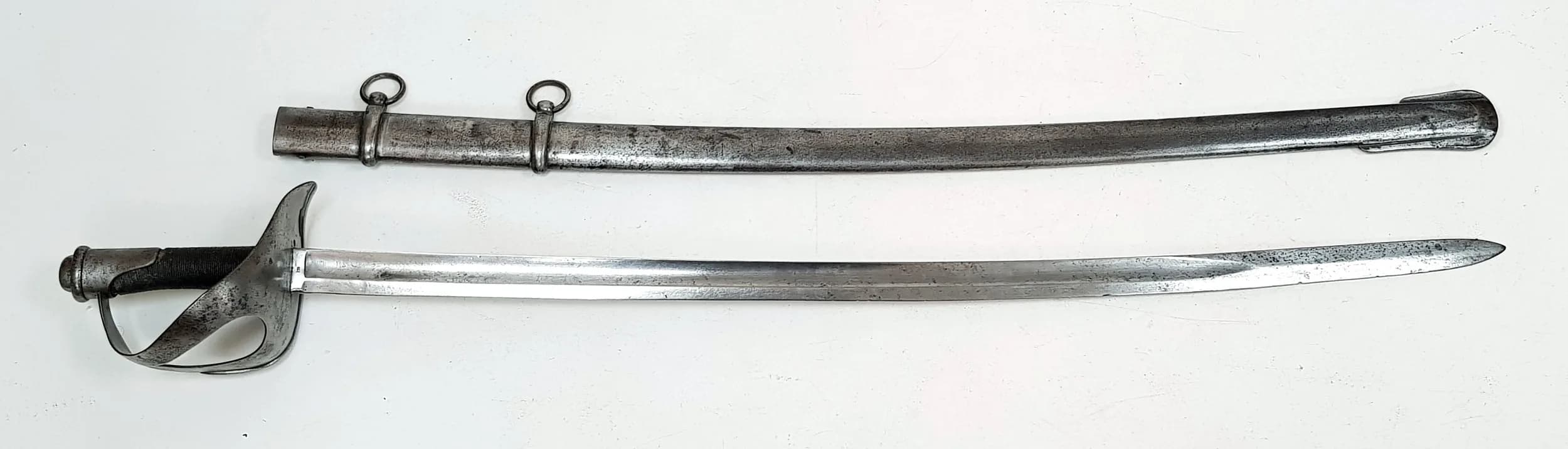 An 1860's Italian Heavy Cavalry Sabre. German made - Schnitzler and Kirschbalm. Large two bar hilt. Leather wrapped handle. Metal scabbard with hanging rings. 110cm total length. UK mainland shipping only.