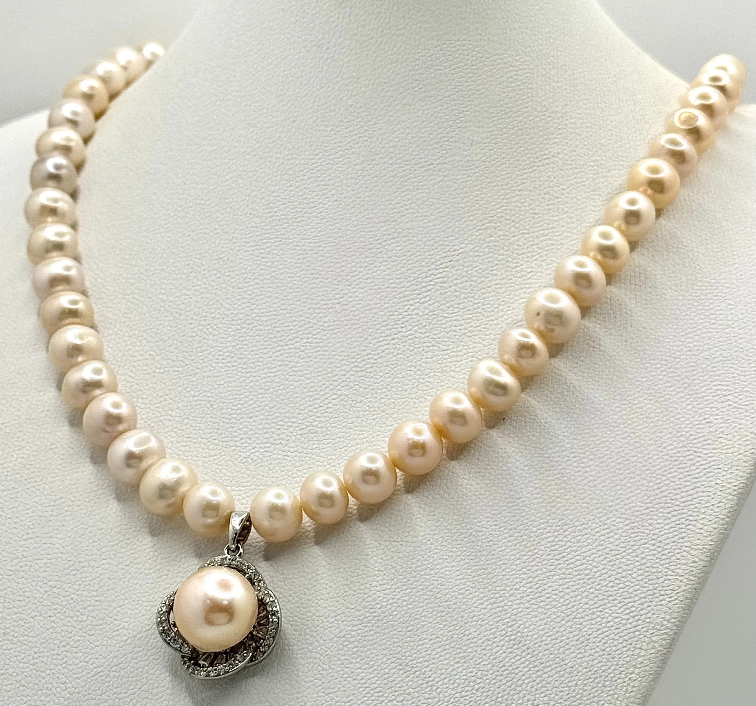 A stunning 925 silver Rose gold colour Freshwater Pearls graduated link necklace with a large pearl set floral pendant drop. Total length 44cm. Pearl pendant 8-10 mm and necklace Pearls 6-8 mm approx.