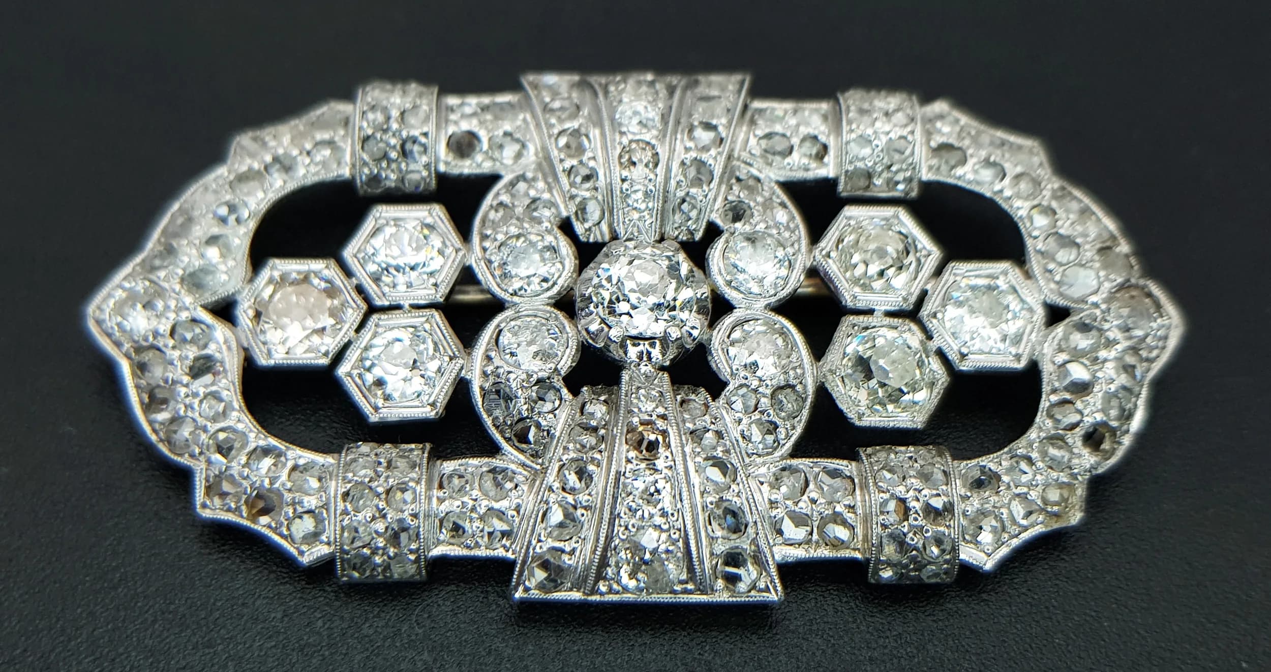 An 18K Gold, Art Deco Style, Partly Rhodium Plated Diamond Brochet. c.4.90ctw of rose and old European cut diamonds having H-L colour with VS2- SI1 clarity. 5.5 x 3cm. 14.75g total weight. Comes with a certificate. TTB054
