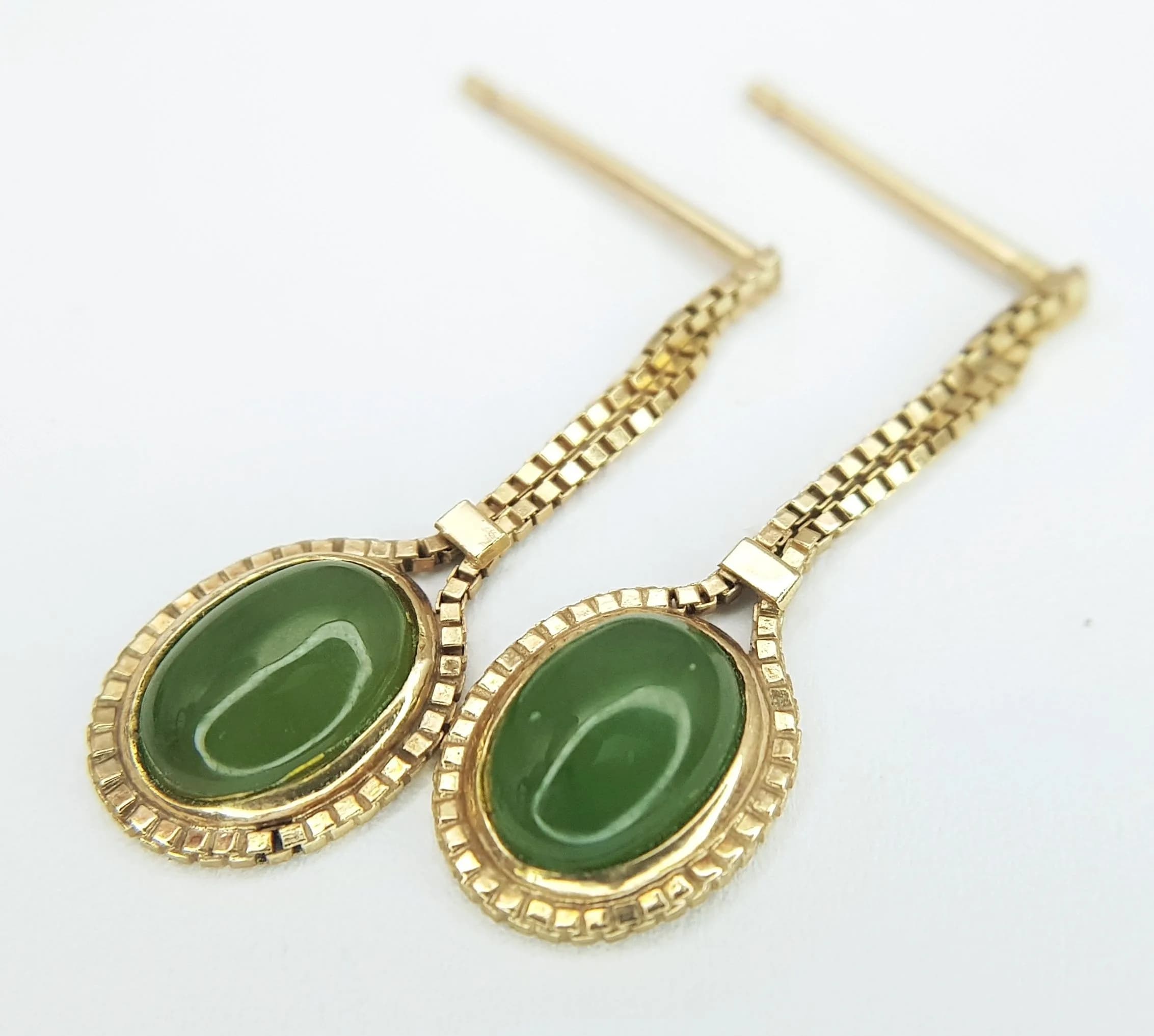 A Pair of 9K Yellow Gold and Jade Cabochon Drop Earrings. 2.5cm drop No backs. 1.3g total weight.