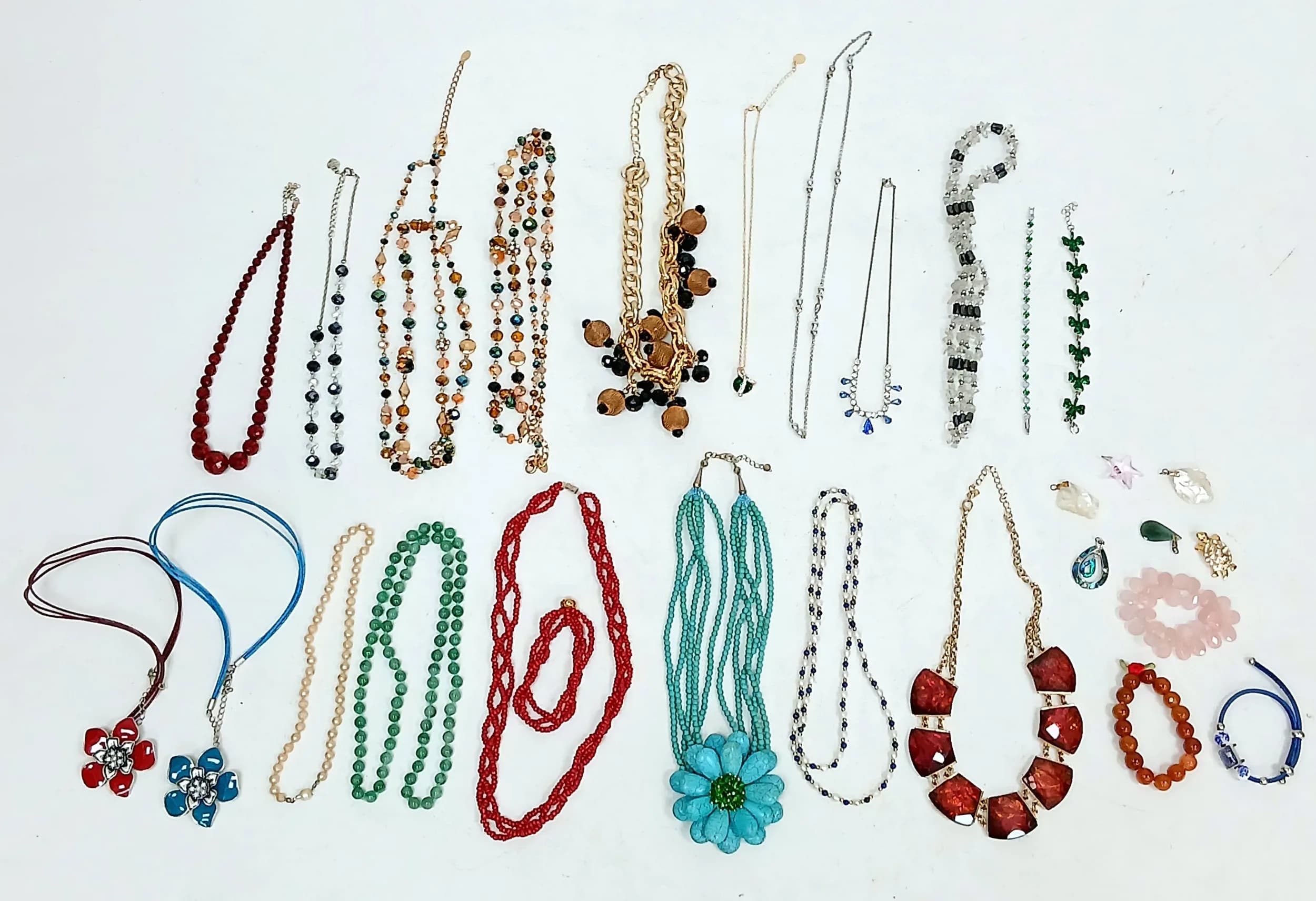 A Collection of Costume Jewellery. Comprising assorted necklaces, bracelets and pendants, to include a 925 silver cross pendant (broken), two mother of pearl pendants, bead bracelets and assorted decorative necklaces.
