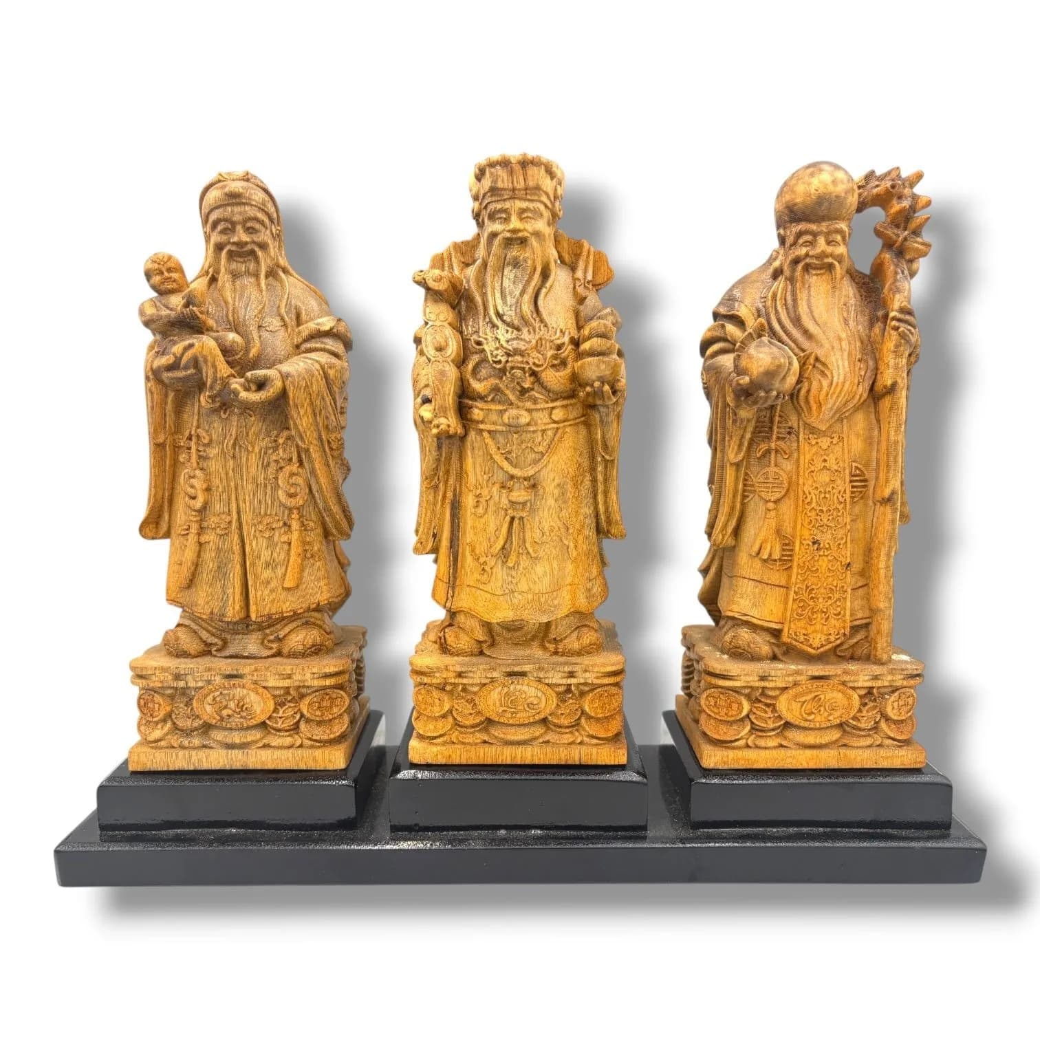 A Set of Three hand Carved natural agarwood Fu Lu Shou Figures. The three Chinese deities of prosperity, status and longevity are finely carved with their traditional attributes and stand on coin-decorated bases.The natural agarwood fragrance is well known for its purposes in relaxation and meditation.Each figure is mounted on an individual black plinth and presented together on a long black display base. Approx 19.5cm height x 7.5cm width each. Some light surface wear and marks. Please see photos or request a condition report.This item is held at Cadmore ASIAN Office in Vietnam and will be shipped from there. Buyers will be responsible for direct shipping payments. Delivery will take slightly longer.