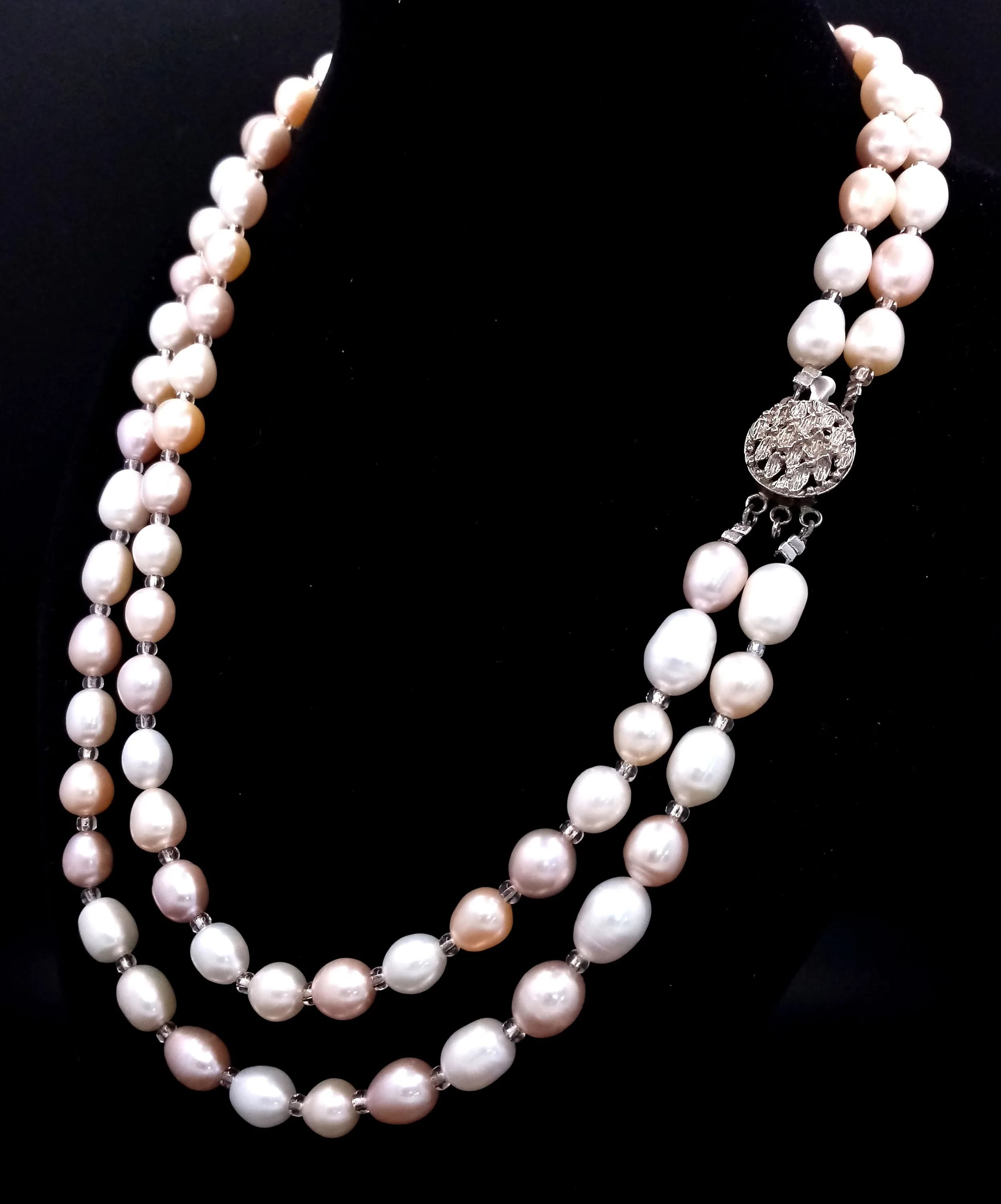 A wonderful Double Strand Freshwater Pearl Necklace. Approx 47cm in length, strung with pink, cream and peach-toned freshwater pearls with small spacer beads, and fitted with a decorative silver box clasp. Please see photos for details.
