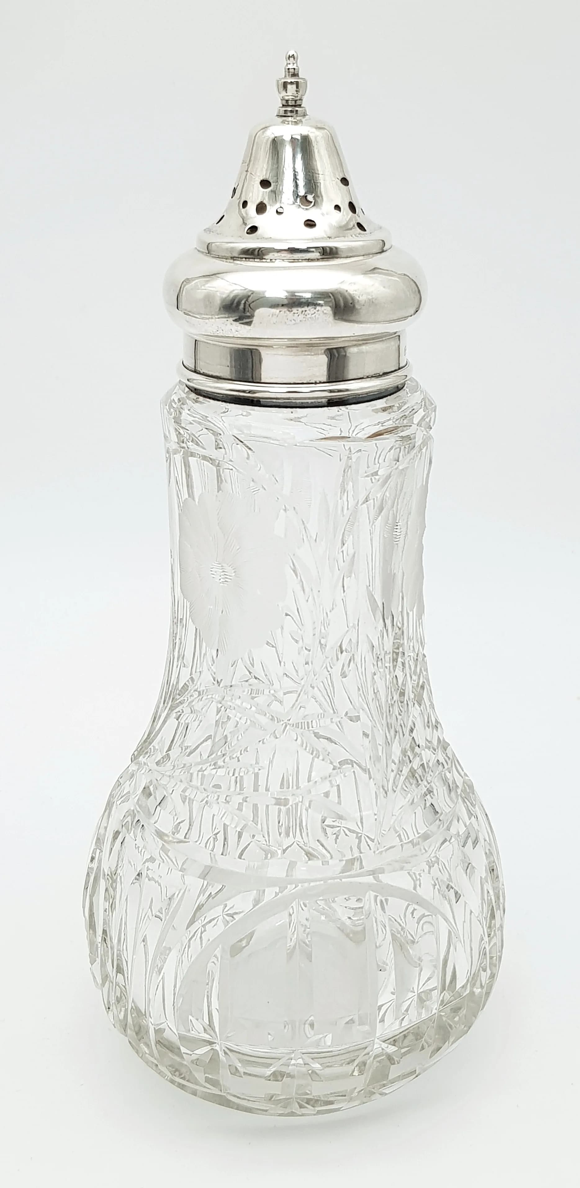 An Antique Silver and Cut Glass Sugar Shaker. Hallmarks for London, 1926. Makers mark HH&SN (Henry Hobson & Sons). 21cm tall, 17.81g silver weight (excluding the collar).