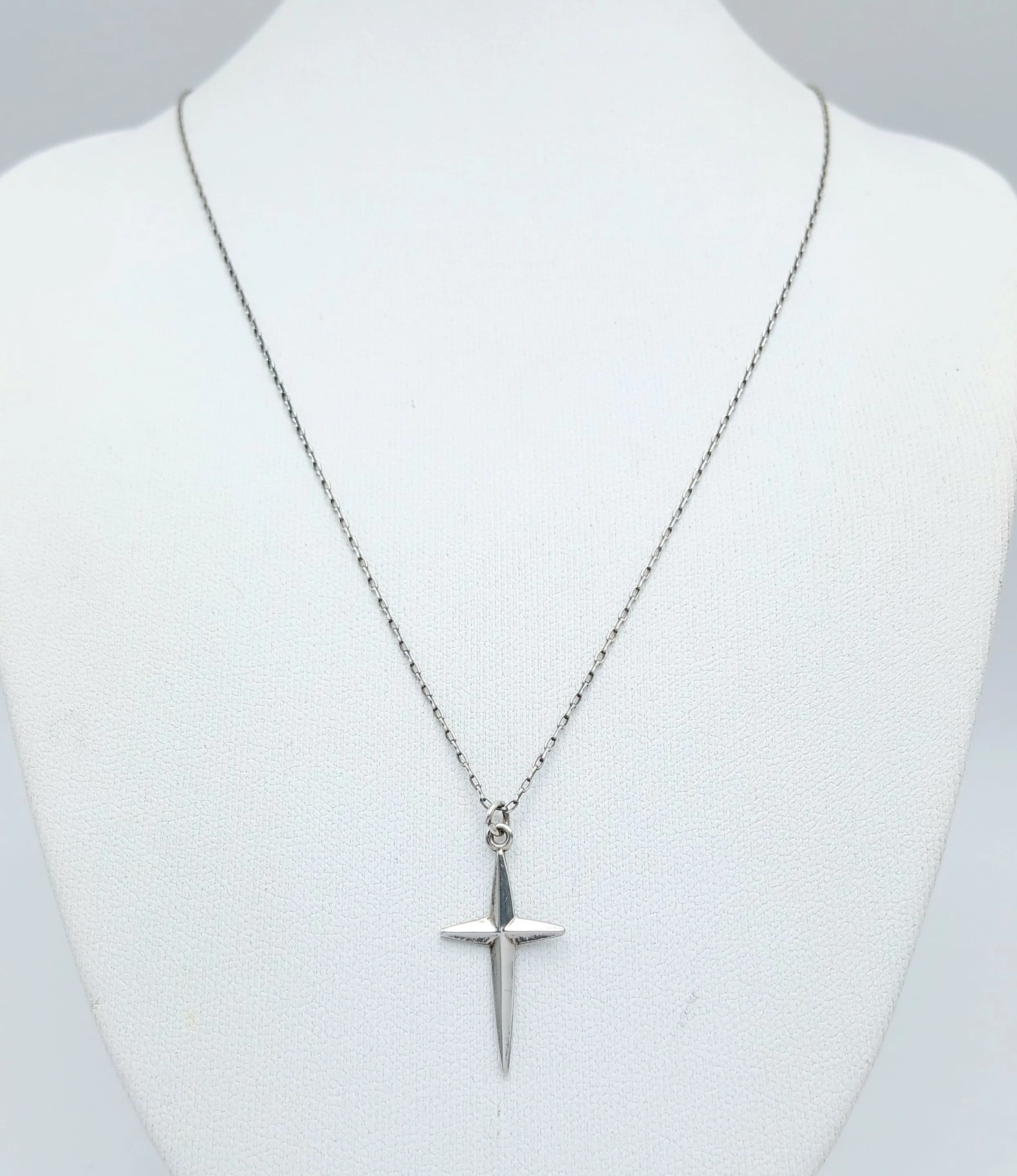 A Lovely Sterling Silver Cross Pendant Necklace-46cm Length Chain. The Pendant has a Polished Cross Design and measures 1.2cm x 2.5cm. The Necklace has a gross weight of 1.67 grams.