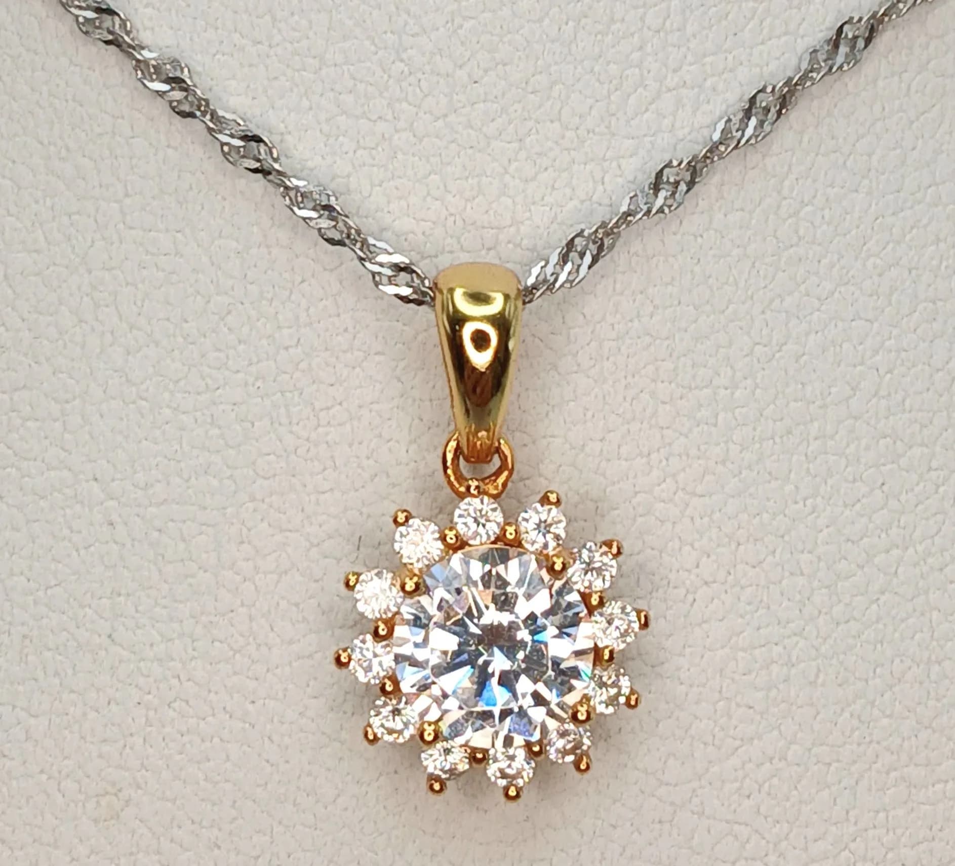 A fancy 925 gilded silver Zirconia cluster floral pendant, set on an Italy silver necklace. Total weight 2.8G. Total length 46cm.