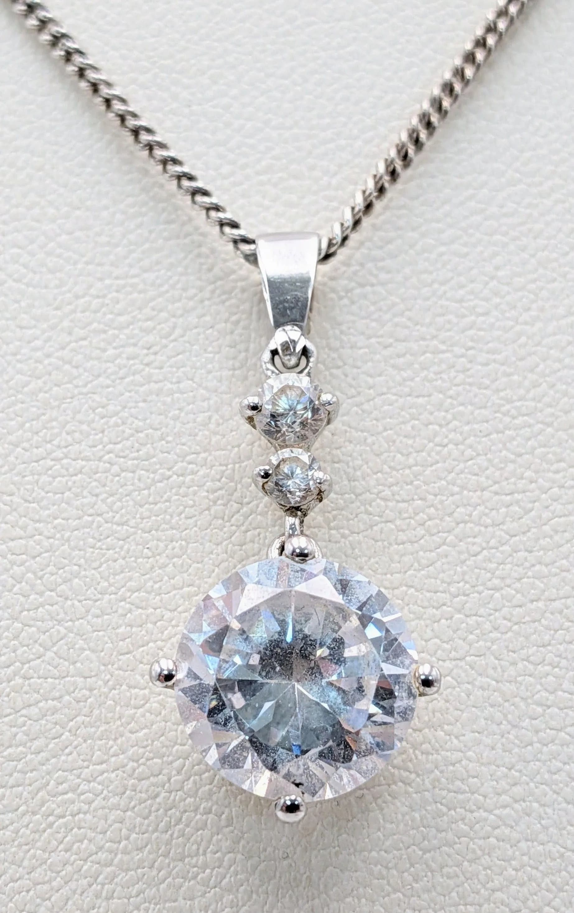 A 925 silver CZ stone set drop pendant, set on a silver necklace. Total weight 6.4G. Total length 46cm.