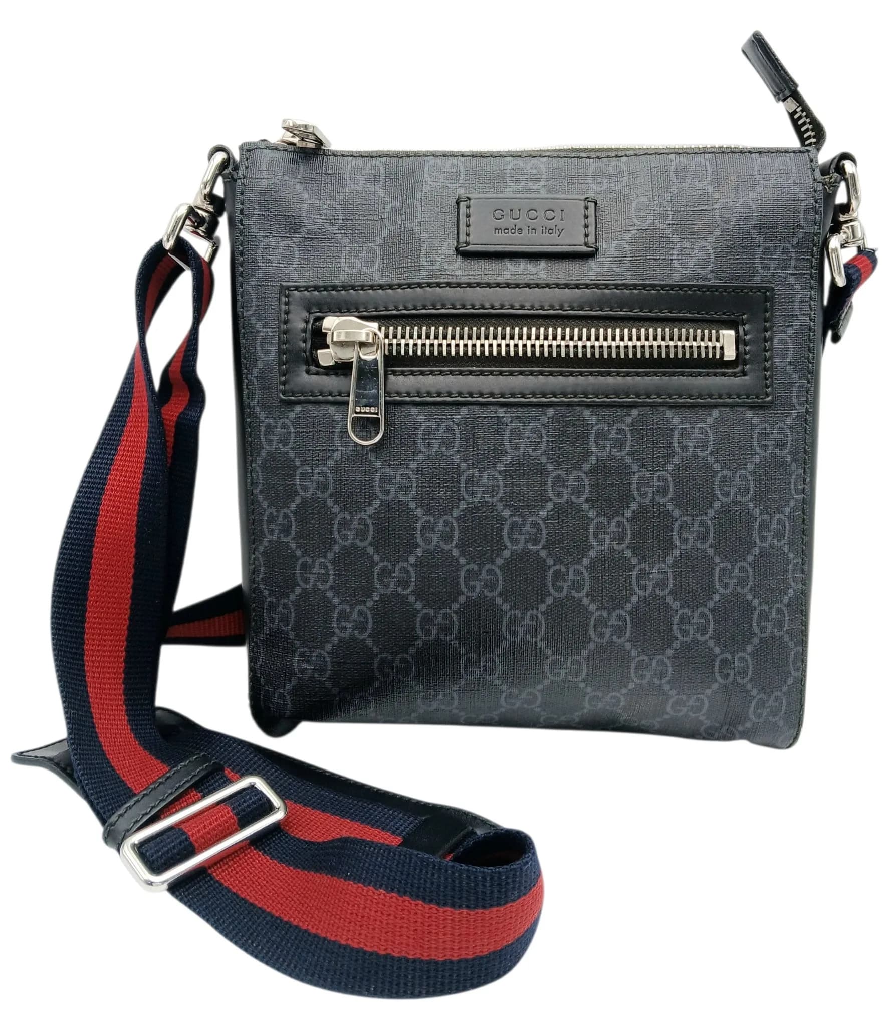 A Gucci Black GG Supreme Canvas Crossbody Bag. Black and grey GG Supreme canvas exterior with silver-toned hardware, adjustable shoulder strap, front zipped pocket and zipped top closure. Black textile interior with one main compartment and open side pockets. Approx 21cm length x 21cm height x 4cm depth. Some stains, signs of wear and tear to the leather and scratches to the hardware. Please see photos or request a condition report. Ref: 28729.
