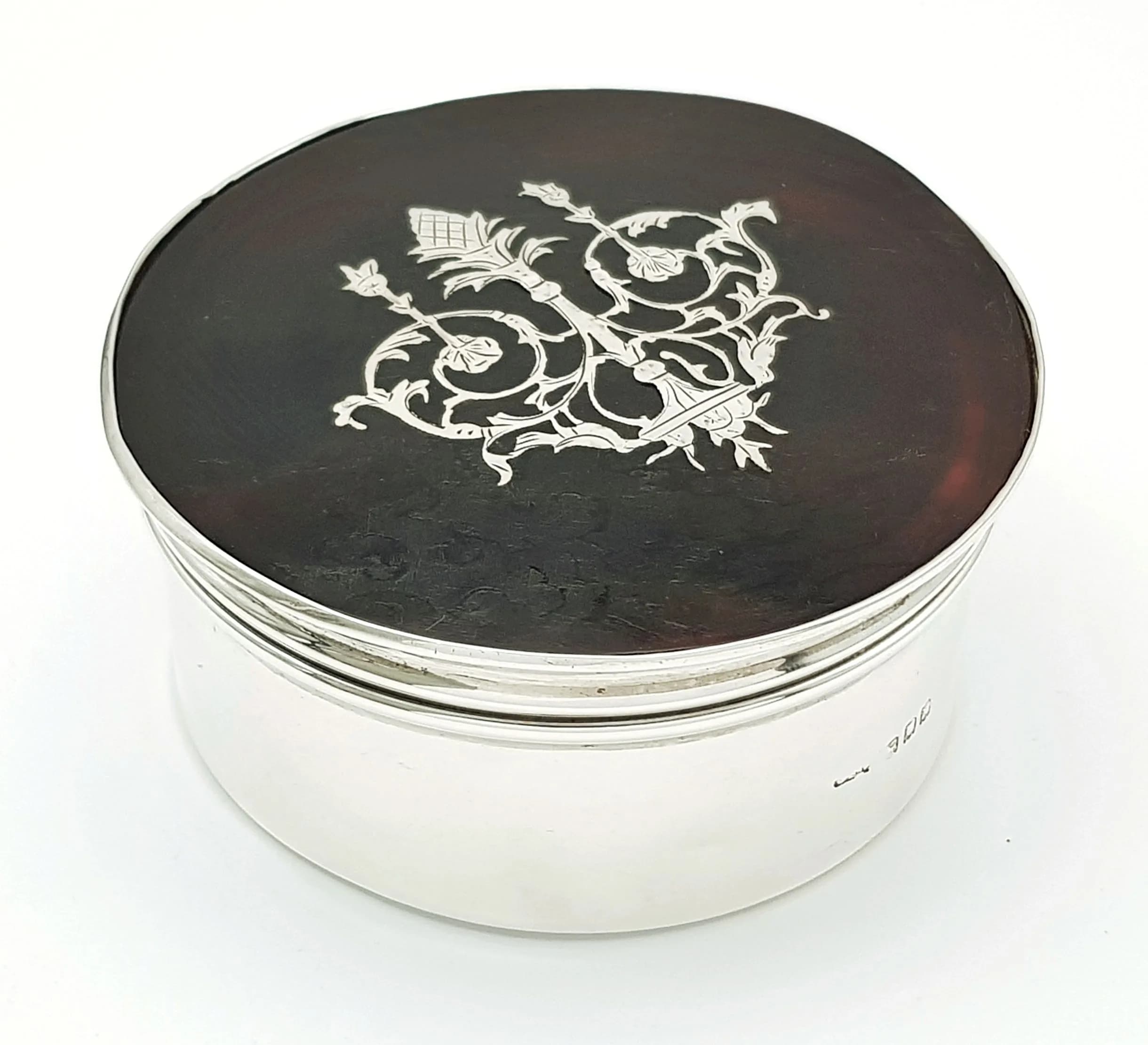 An Antique Sterling Silver and Tortoise Shell Trinket Box. Velvet lining. Hallmarks for London, 1916. 9cm length x 4cm height. 169.41g total weight.