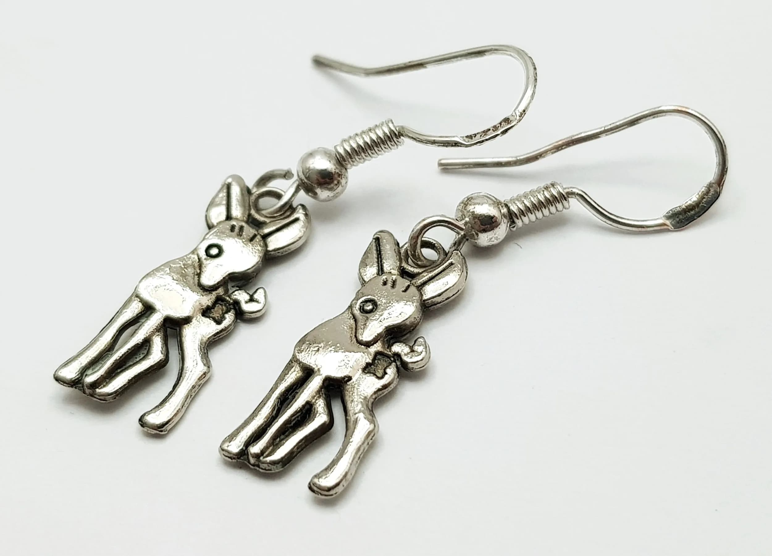 A Cute Pair of 925 Sterling Silver Deer Drop Earrings. Features deer-shaped drops with fish hook fittings. Each earring measures 2cm x 0.7cm. Gross weight 1.79 grams.