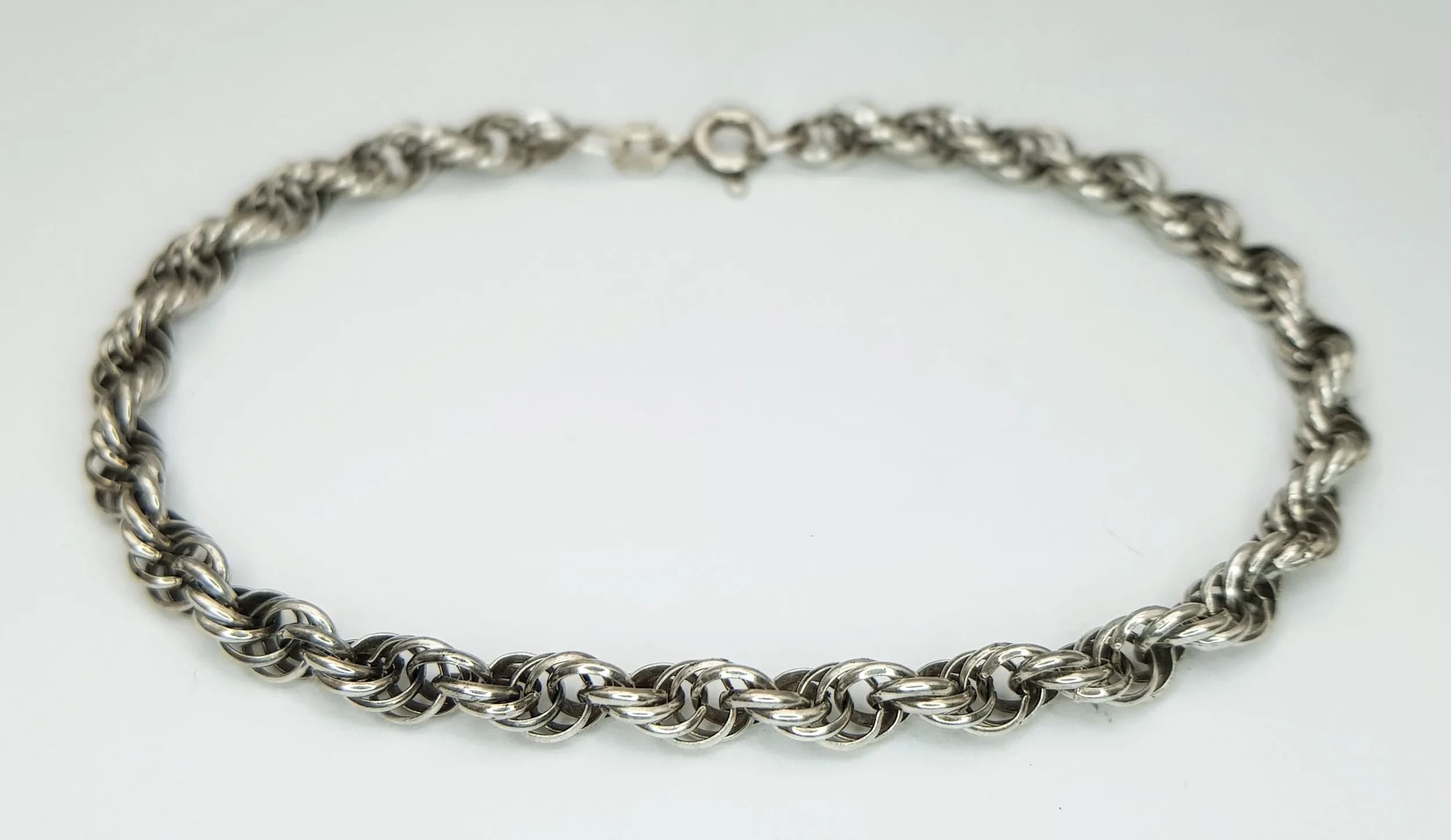 A Stylish 925 Sterling Silver Rope Link Bracelet - 18cm Length. Features a twisted rope link design with a spring ring clasp fastening. Gross weight 5.04 grams.