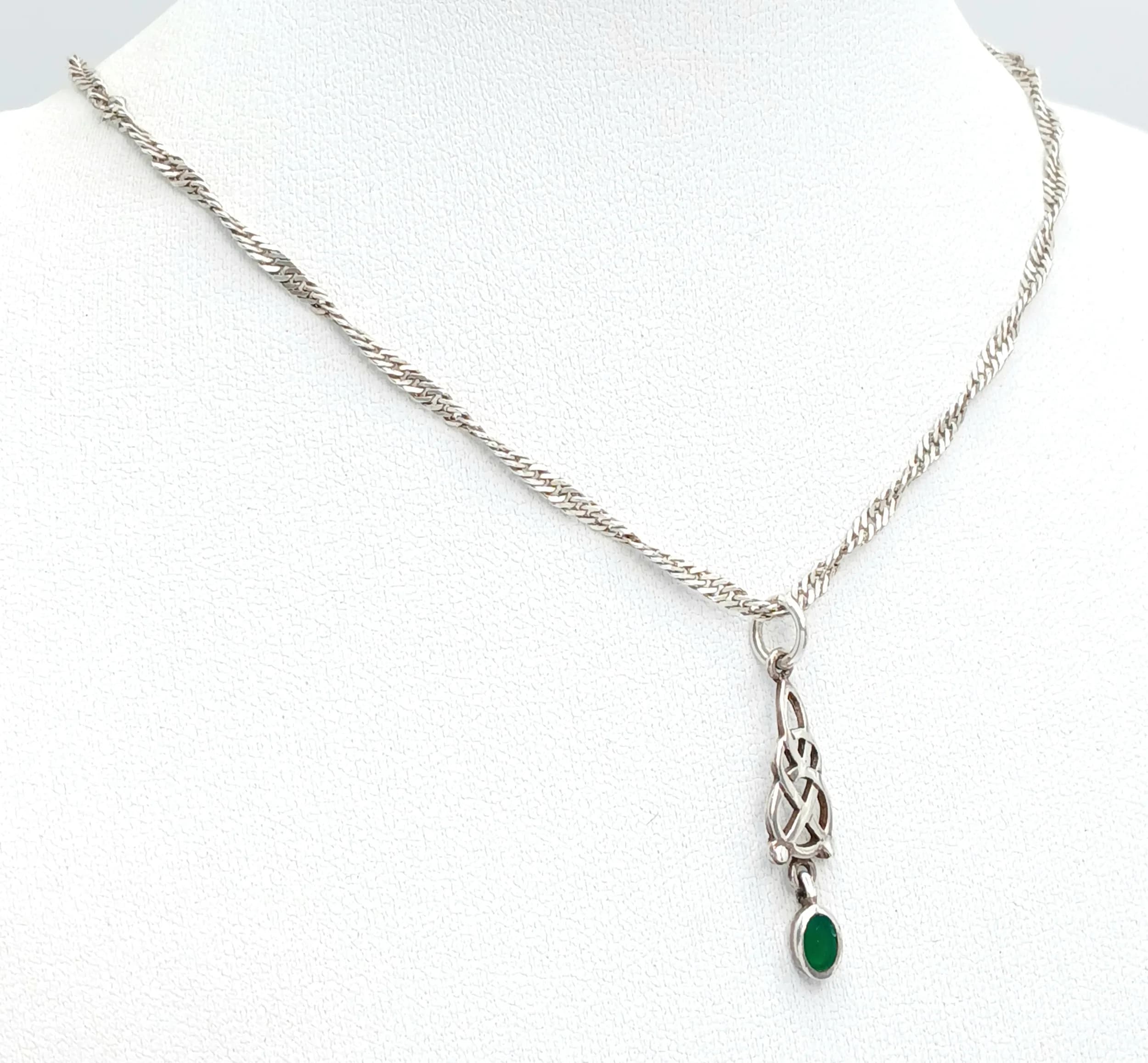 A 925 Italy Silver Green Stone Set Celtic Knot Pendant Necklace. Total weight 4.72g. Approx 46cm chain length with a 2cm pendant drop.