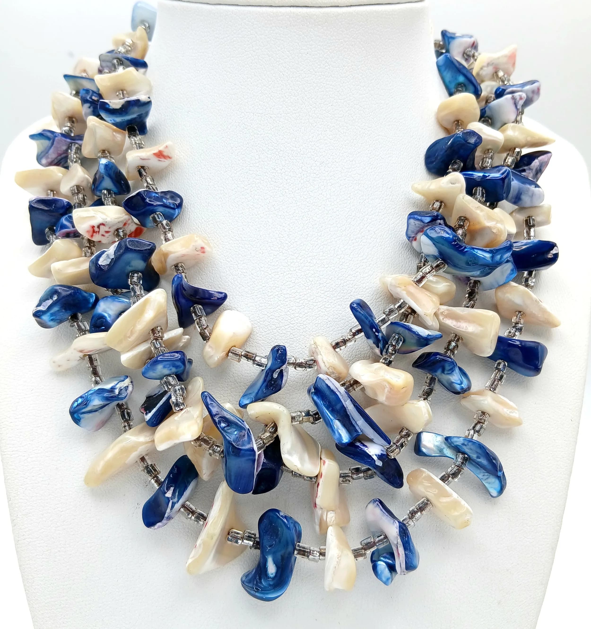 A Pretty Multi-Strand Blue and White Shell Chip Necklace - 34cm Length. Features multiple strands of irregular blue and white shell chips.