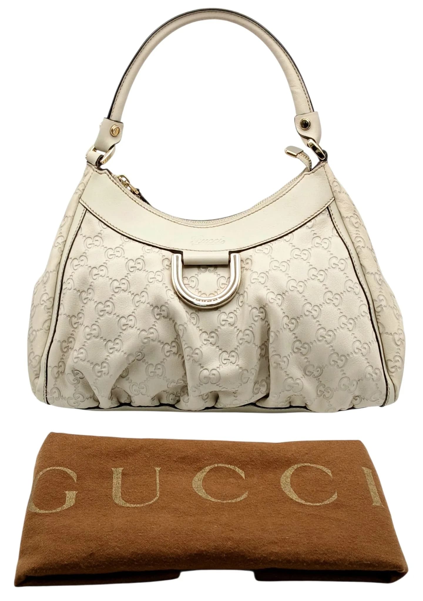 A Gucci Guccissima Cream Leather Hobo Shoulder Bag. Cream Guccissima embossed leather exterior with gold-toned hardware, single rolled top handle, zip-top closure and signature horsebit-inspired front detail. Brown fabric-lined interior with one main compartment and zipped side pocket. Approx. 29cm length x 21cm height x 7cm depth. Some marks, stains, signs of wear to the leather. Comes with a dust cover. Please see photos or request a condition report. Ref: 29504.