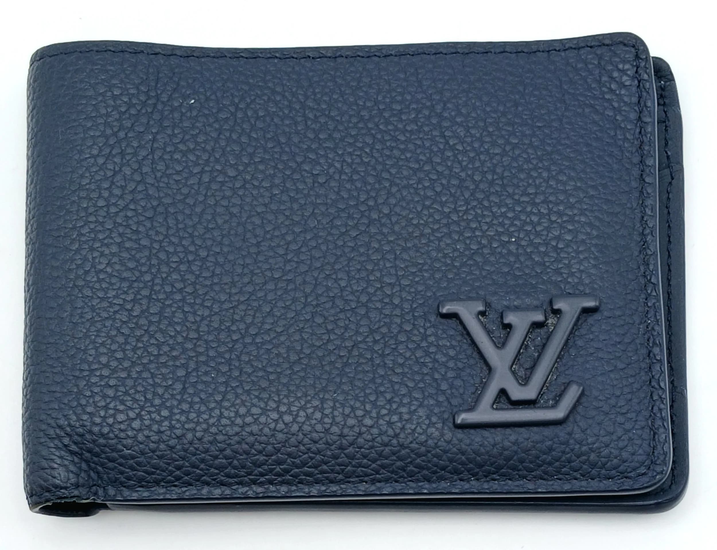 A Louis Vuitton Blue Leather Wallet. Blue leather exterior with LV logo to the front. Opens to a matching blue leather interior featuring multiple card slots and note compartments. Approx. 11cm length x 9cm height (when folded). Comes with original Louis Vuitton box and dust cover. Please see photos or request a condition report. Ref: 29261.