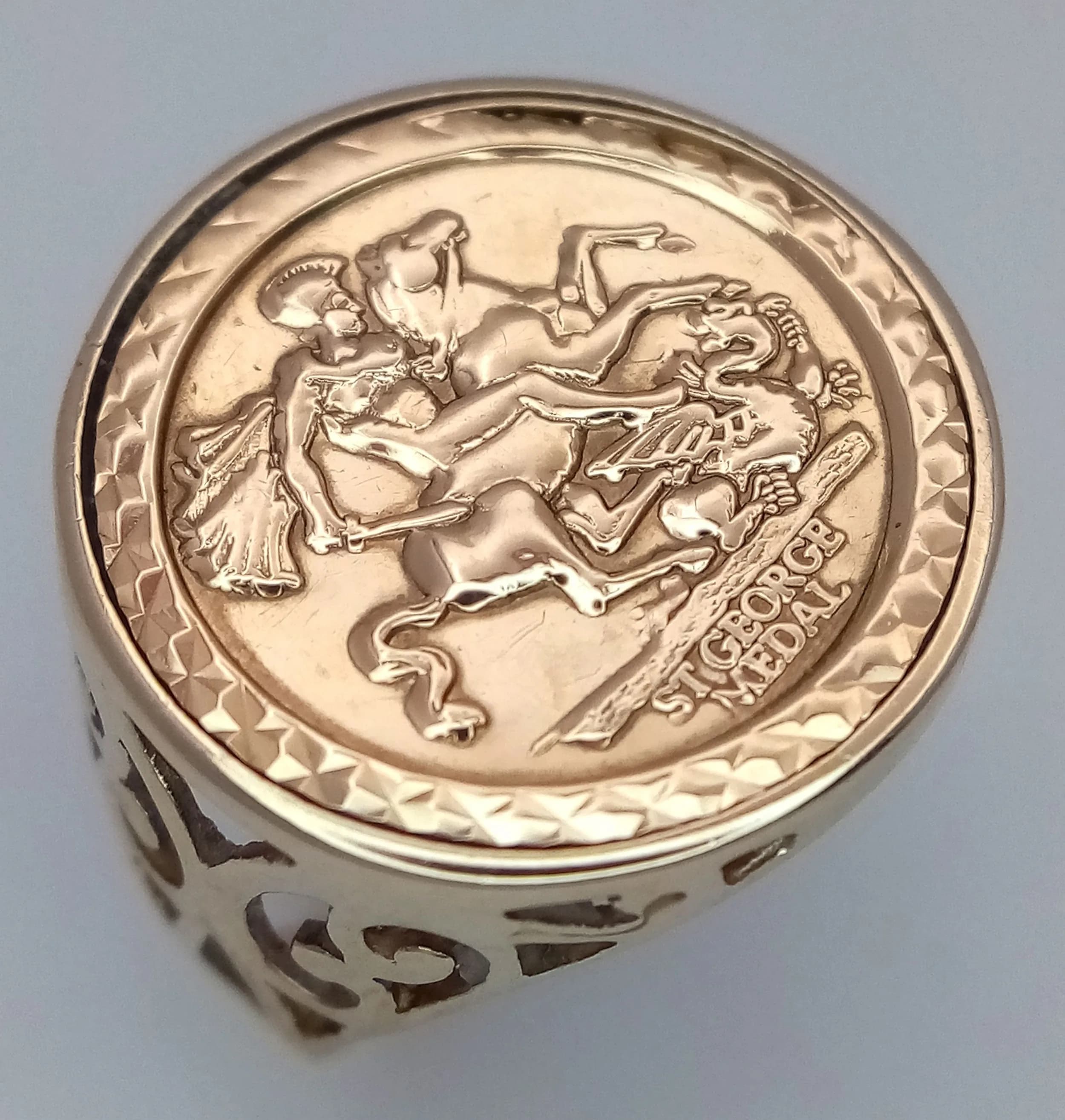A 9K Yellow Gold St. George Medallion Ring. 18mm diameter.Size K. 2.8g.