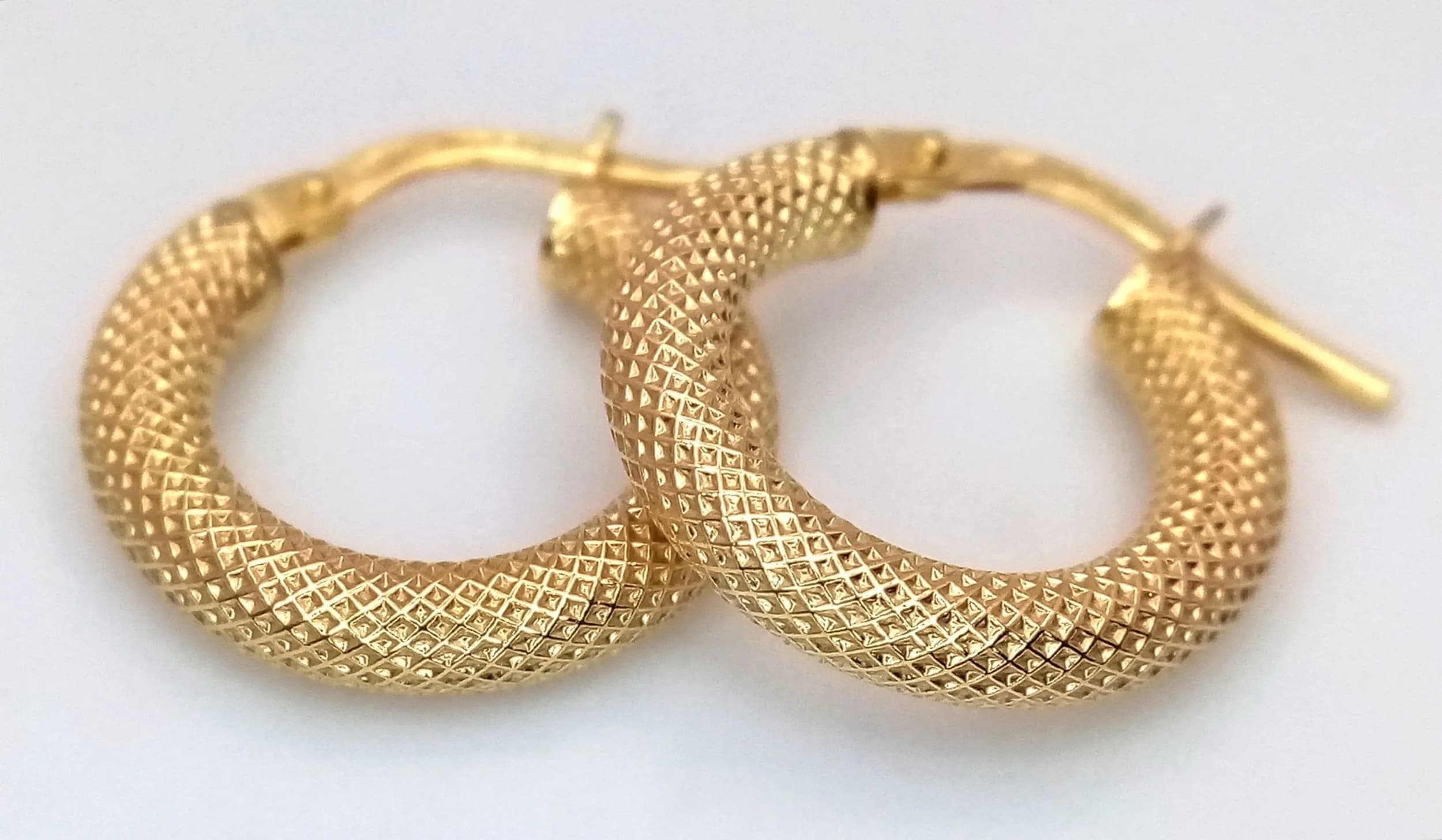 A Pair of 9K Yellow Gold Italian Hoop Earrings with Woven Decoration. 17mm diameter. 1.05g.