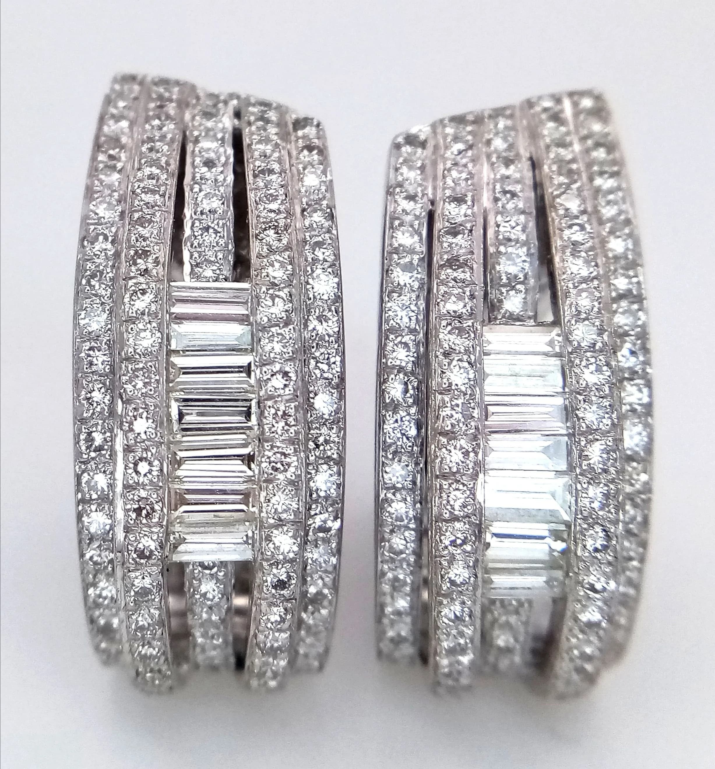 A Pair of Head-Turning 18K White Gold and Diamond Dress Earrings. A beautiful huggie design incorporating baguette and round brilliant cut diamonds. Circa 2ctw having G-H colour and SI1 clarity. 14.55g total weight. 4cm hug. Ref: 027891.