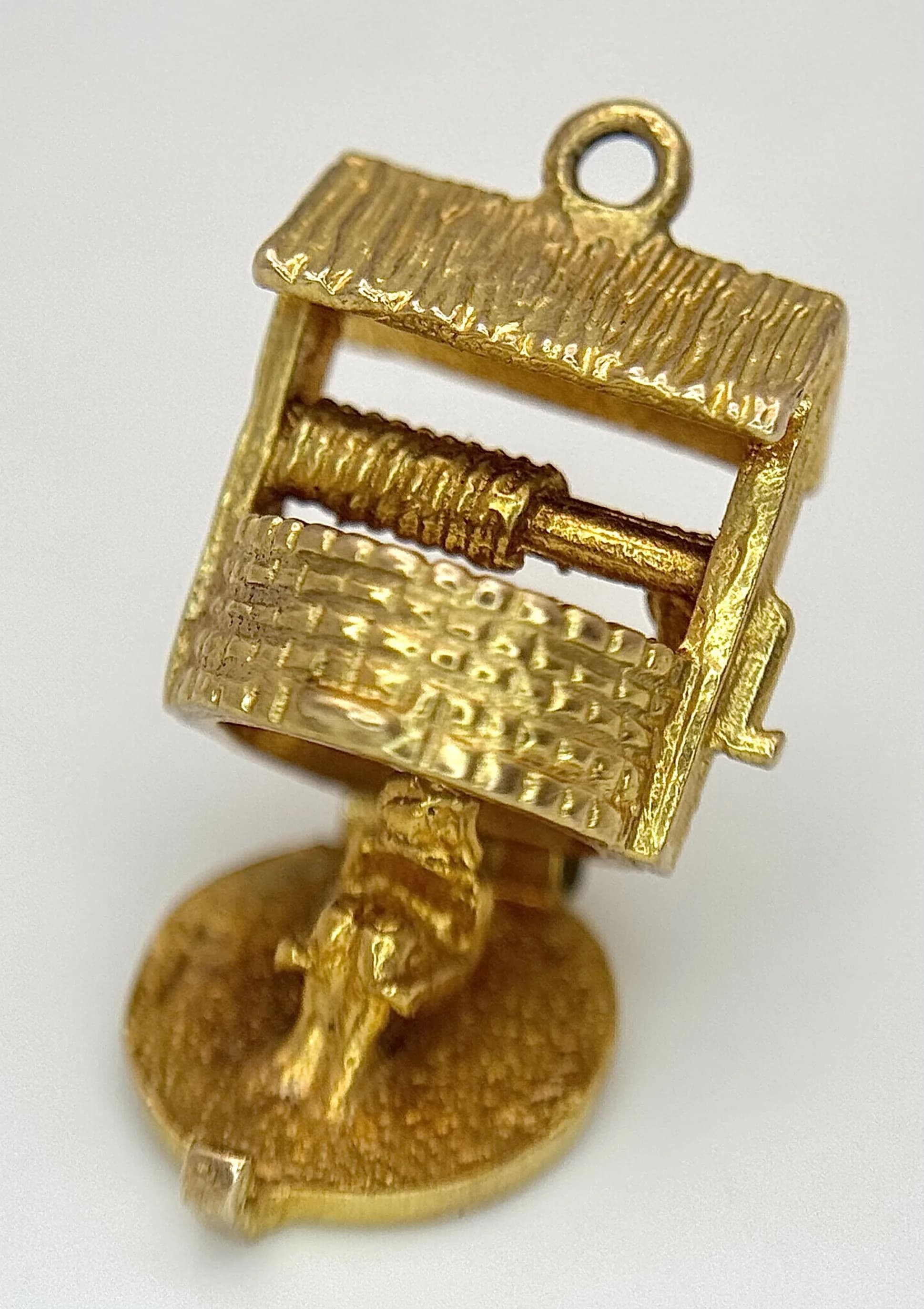 A 9K Yellow Gold Wishing Well Pendant/Charm. The bottom has a rocky reputation. 12mm. 2.2g.