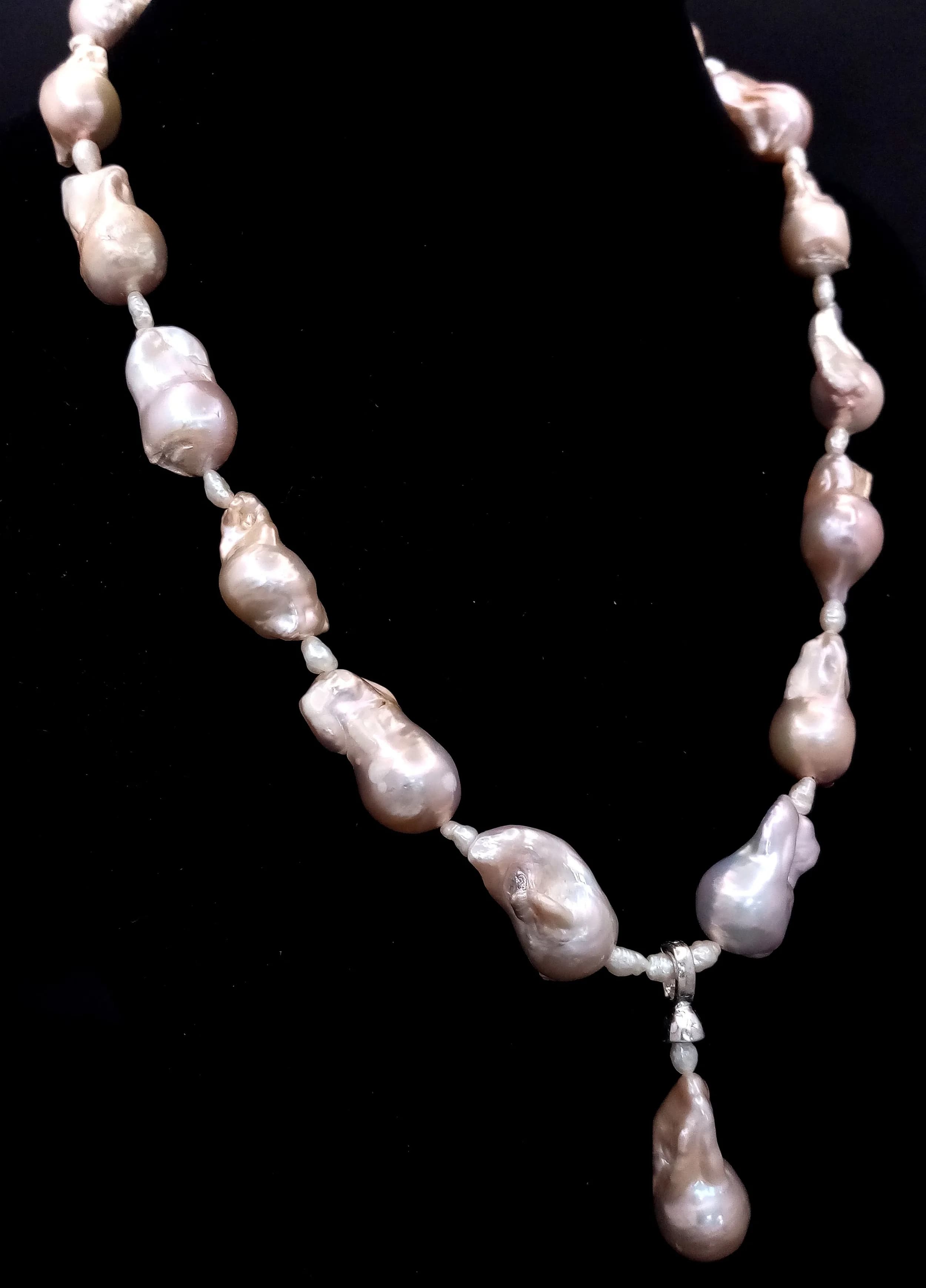 A striking Baroque Freshwater Pearl Necklace. Approx 45cm in length, strung with large irregular baroque pearls and fitted with a decorative box clasp. With detachable pearl drop pendant.