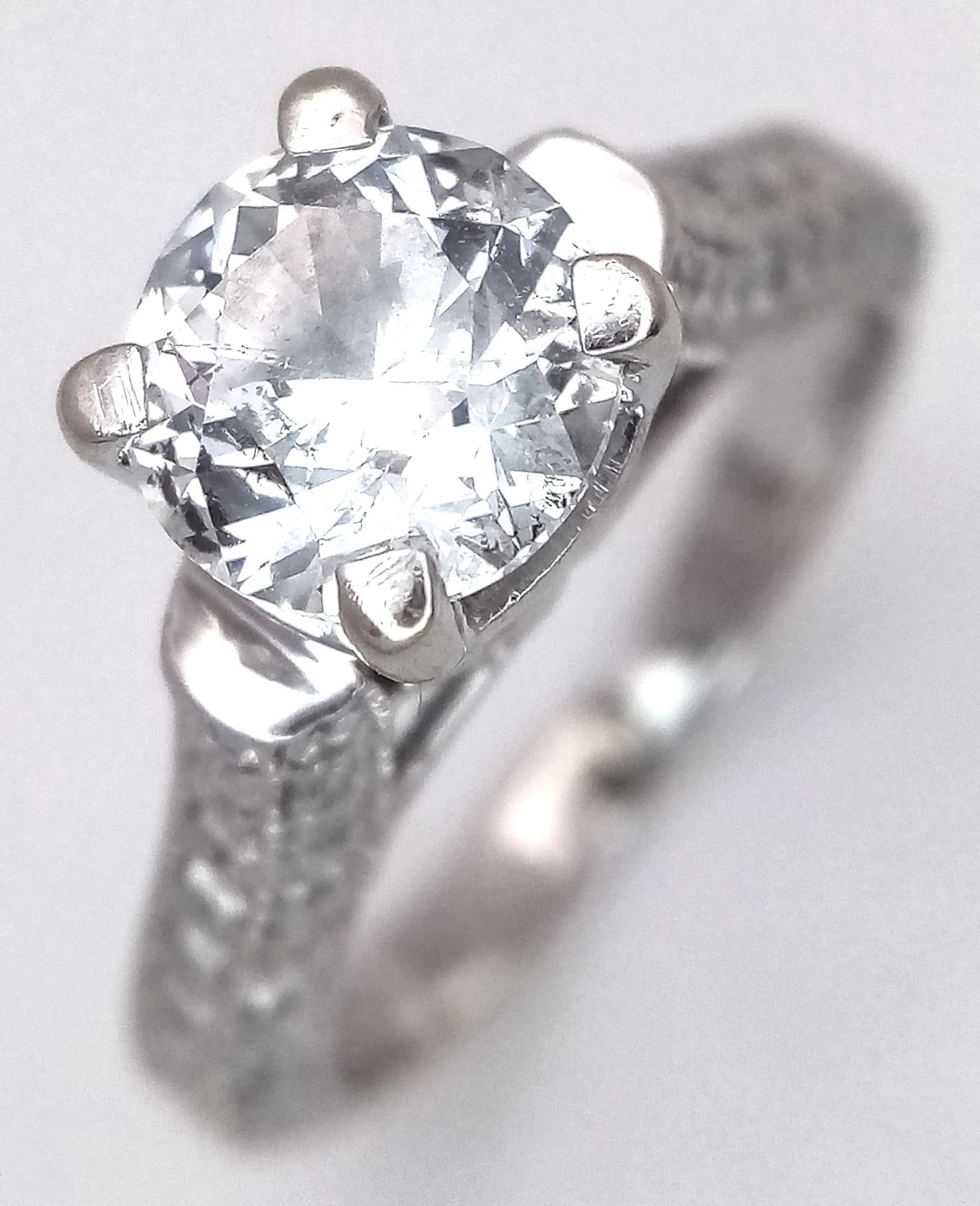A 2.2ct Diamond and 14K White Gold Ring. A 2.2ct round brilliant cut centre diamond having F/G colour and SI2 clarity. Diamond accents on shoulders. Size K 1/2. 3.4g total weight.