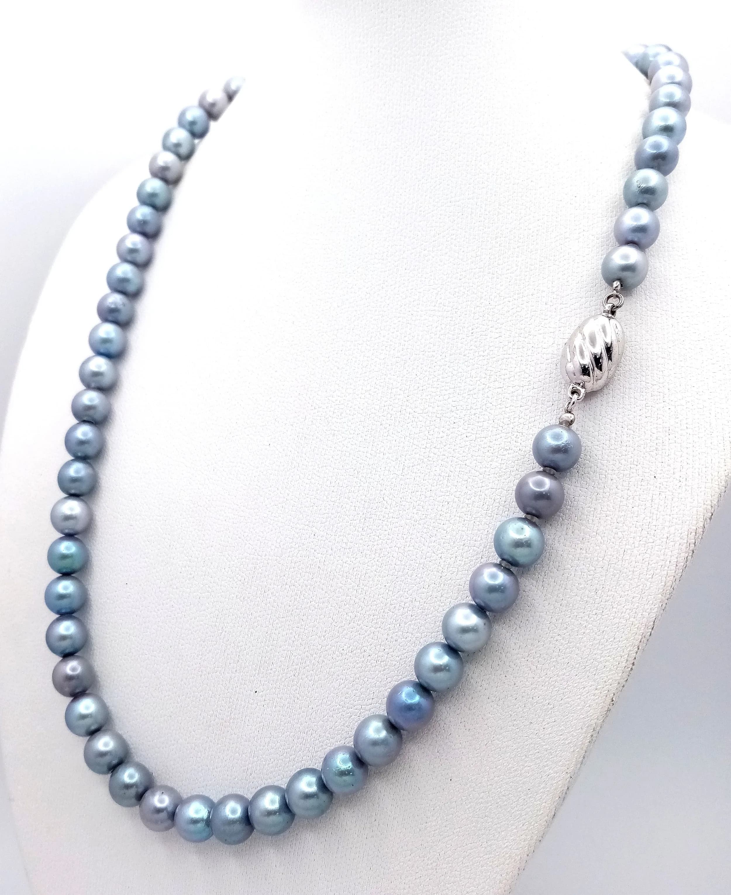 A classic single strand of large Metallic Blue Freshwater Pearl Necklace. Approx 43cm in length, strung with blue freshwater pearls and fitted with a silver bean clasp.