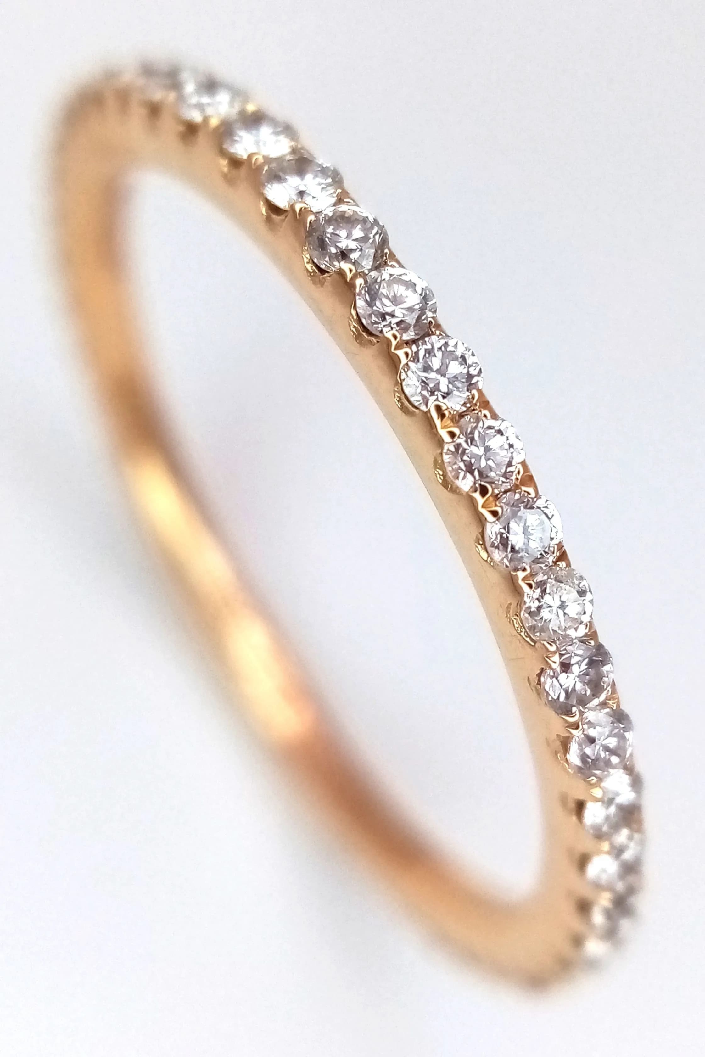 An 18K Yellow Gold and Diamond Full Eternity Band Ring. 0.46ctw of round brilliant cut diamonds having F colour and VS1 clarity. 2.5mm width. Size M 1/2. 1.65g total weight. MT13.