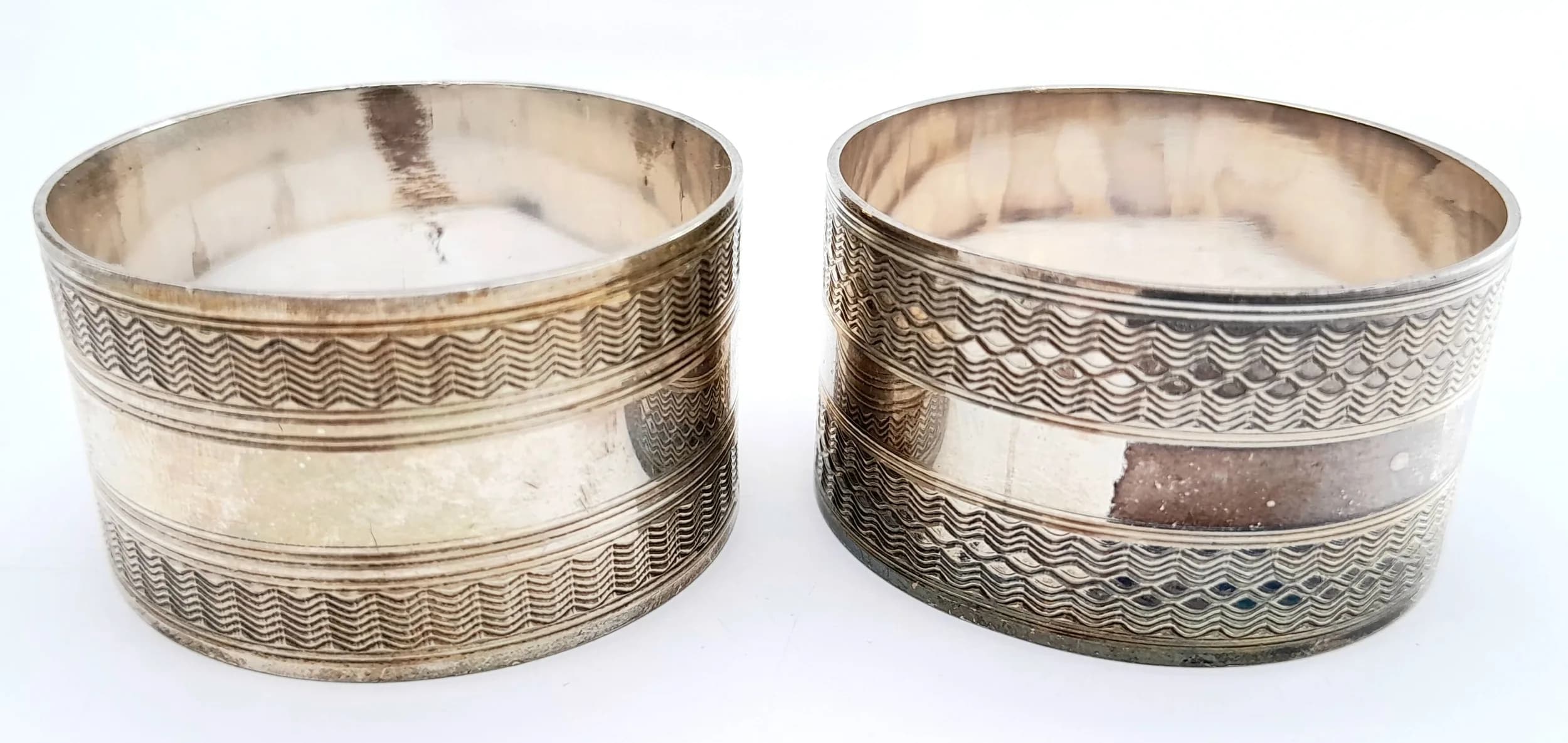 A Pair of Sterling Silver Napkin Rings. Hallmarks for Birmingham 1945. 64.5g total weight. Arnold Williams makers mark.