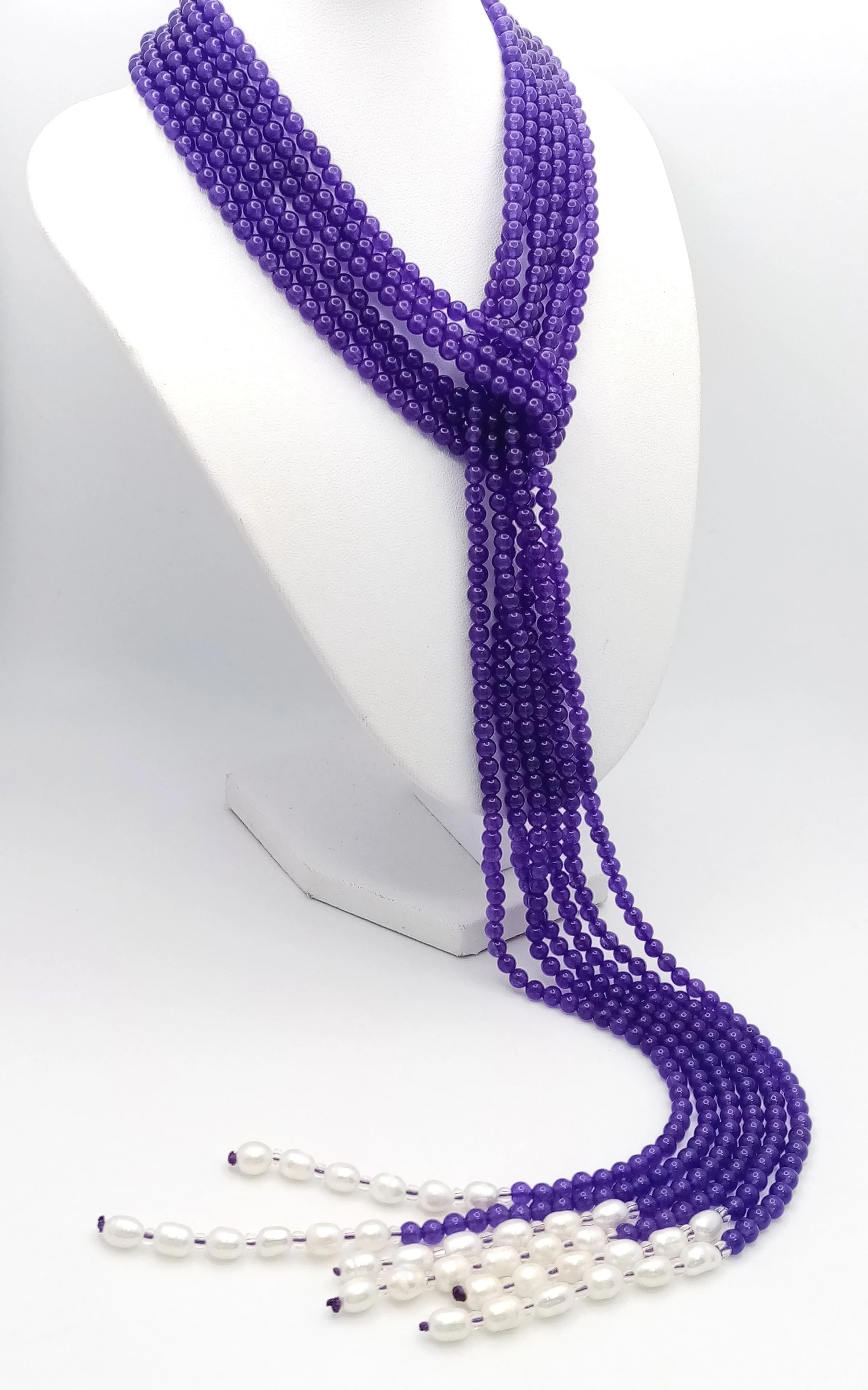 A Purple Jade and Freshwater Pearl Three Strand Scarf Necklace. Each strand c.125cm.