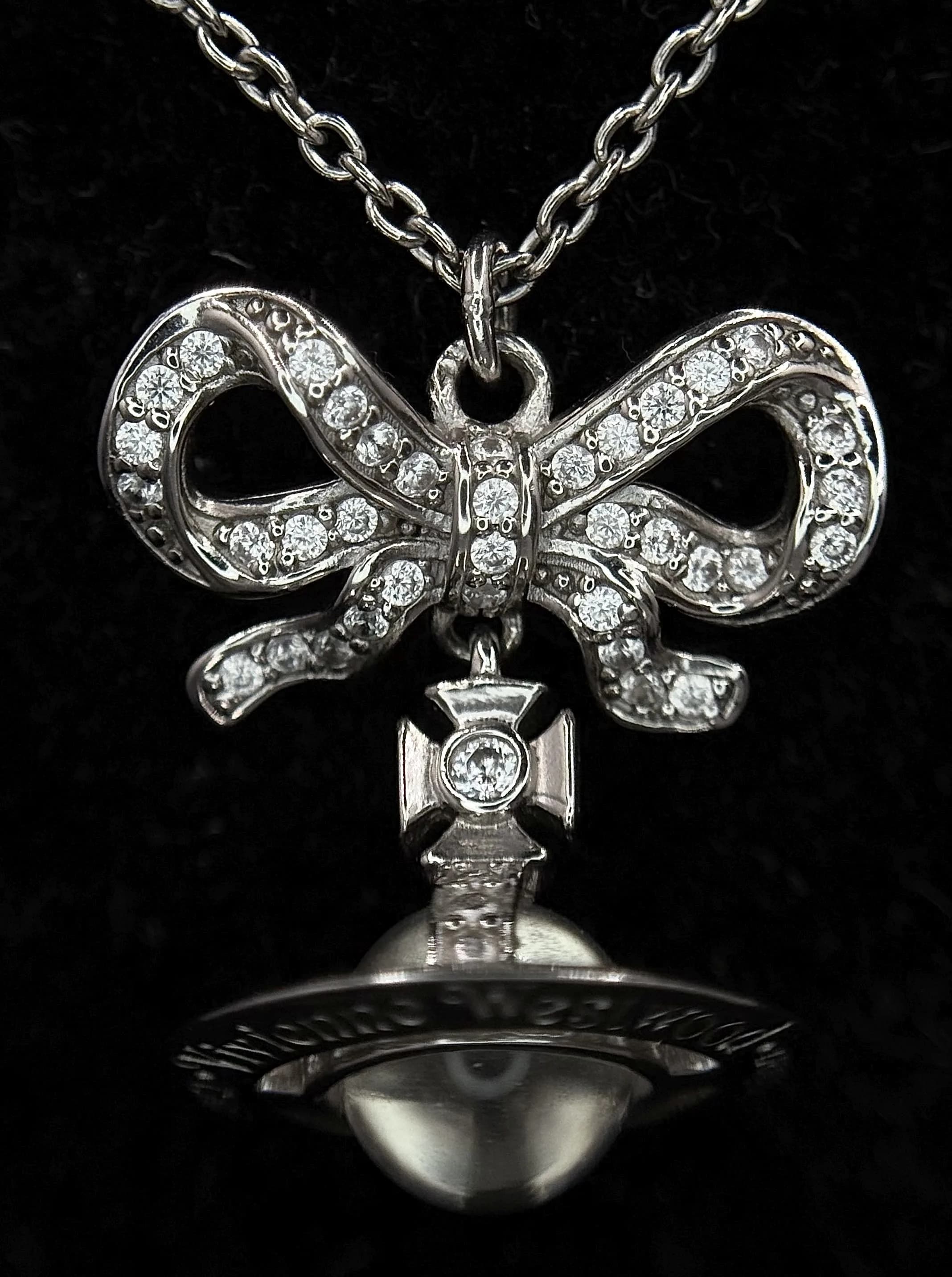 A Pretty Vivienne Westwood Silver Tone Orb Pendant Necklace - 44.5cm Length. Features a white stone set orb pendant on a fine chain with an extension chain. The pendant measures 2cm drop. Comes with original box, dust bag and care booklet.