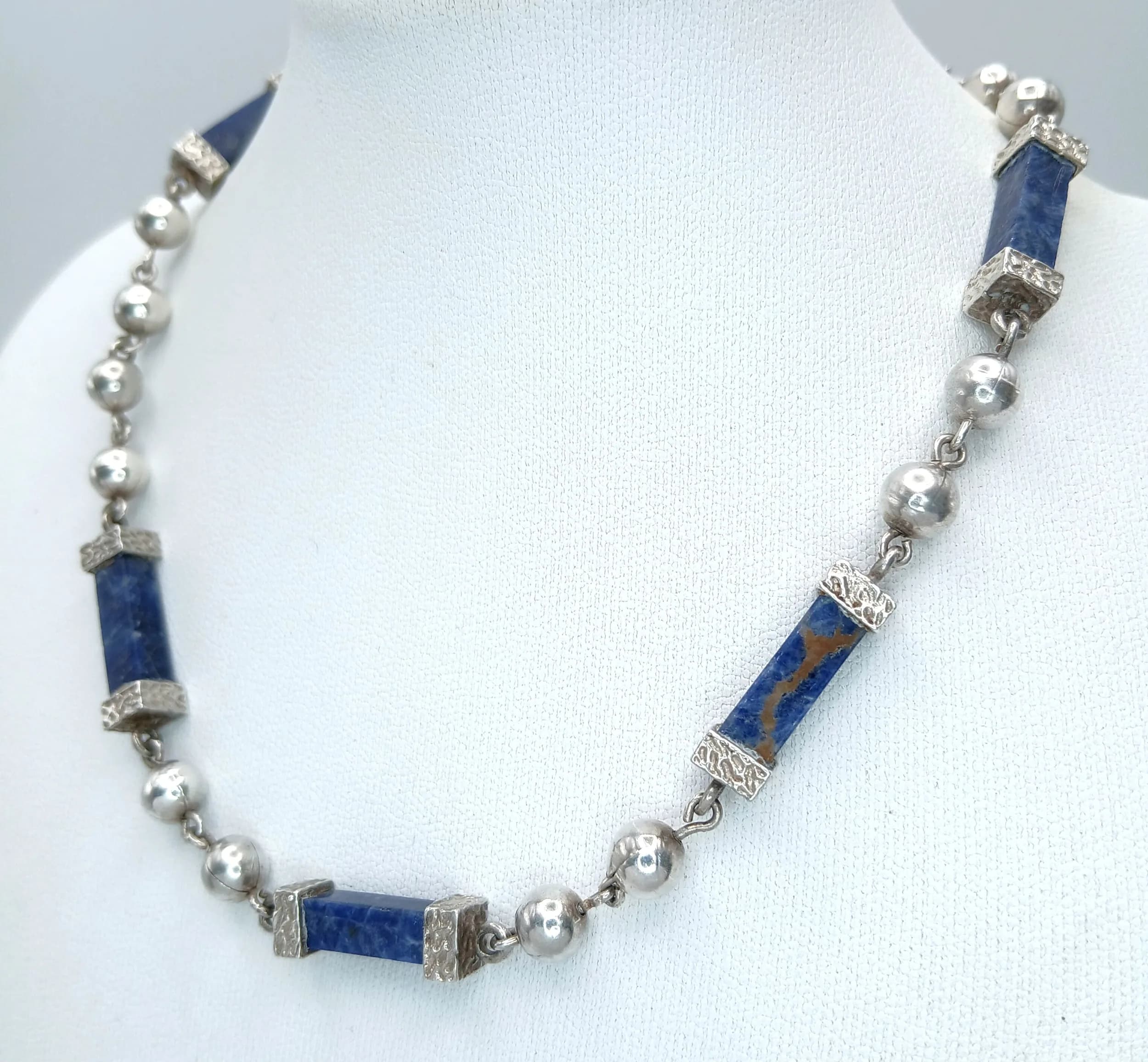 A Pretty Silver Lapis Lazuli Anklet - 32cm length. Features polished lapis lazuli baton beads with silver bead spacers. Gross weight of 18 grams.