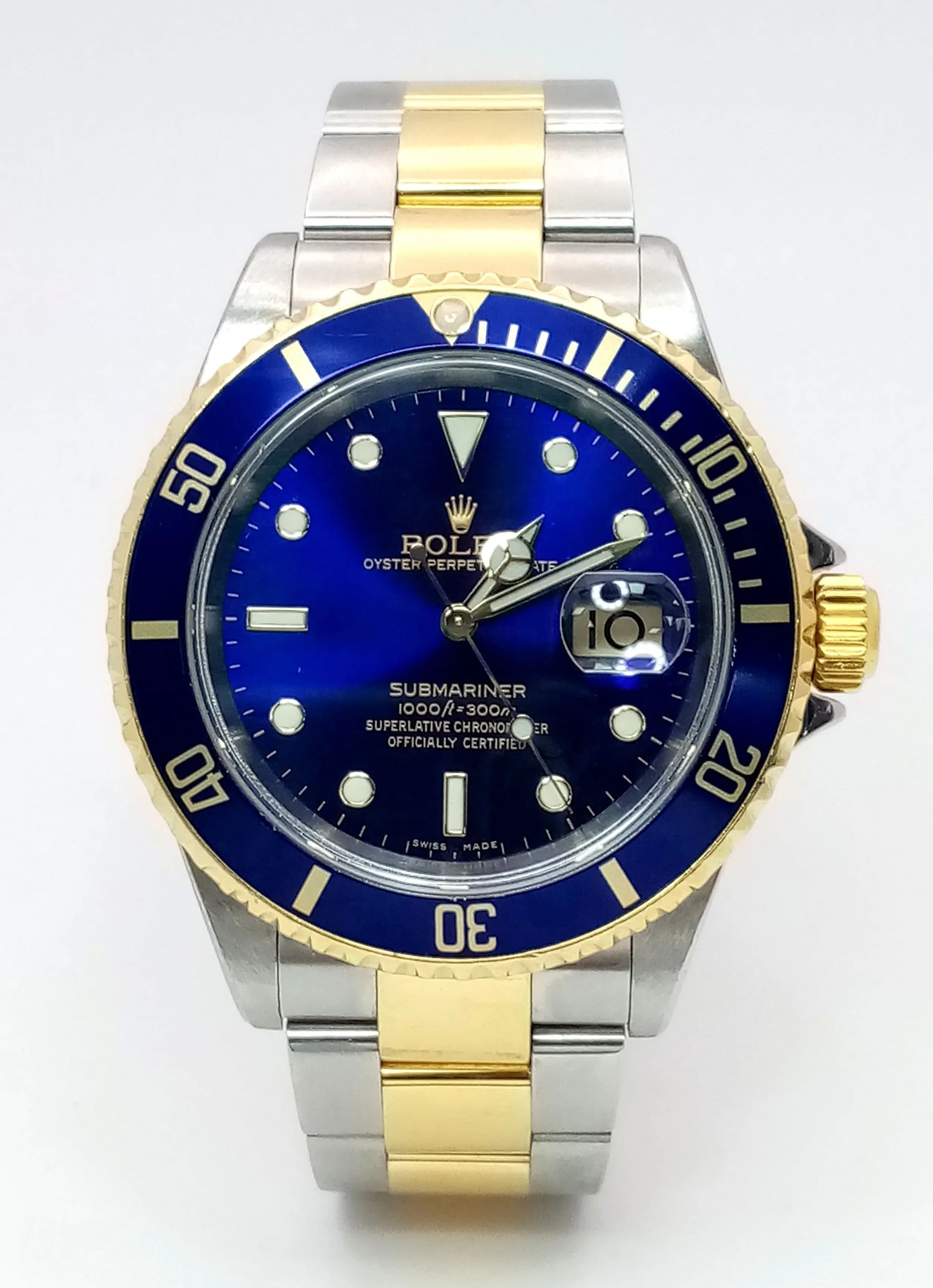 A Wonderful Rolex Submariner 'Bluesy' Automatic Gents Watch. Model 16613. Circa 2004. 18K gold and stainless steel oyster bracelet. Folding clasp. Stainless steel case with rotating blue and gold bezel - 40mm. Blue dial with date window. In working order. Comes with box, wallet, papers and watch register report. Ref: C-6009.