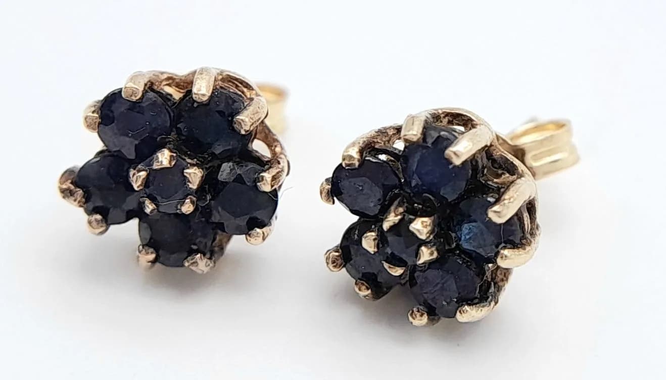 A Pair of 9k Yellow Gold Sapphire Blue Spinel Stud Earrings. 7mm Diameter. Set with a cluster of round cut Sapphire Colour Blue Spinel. Combined gross weight 1.2 grams.