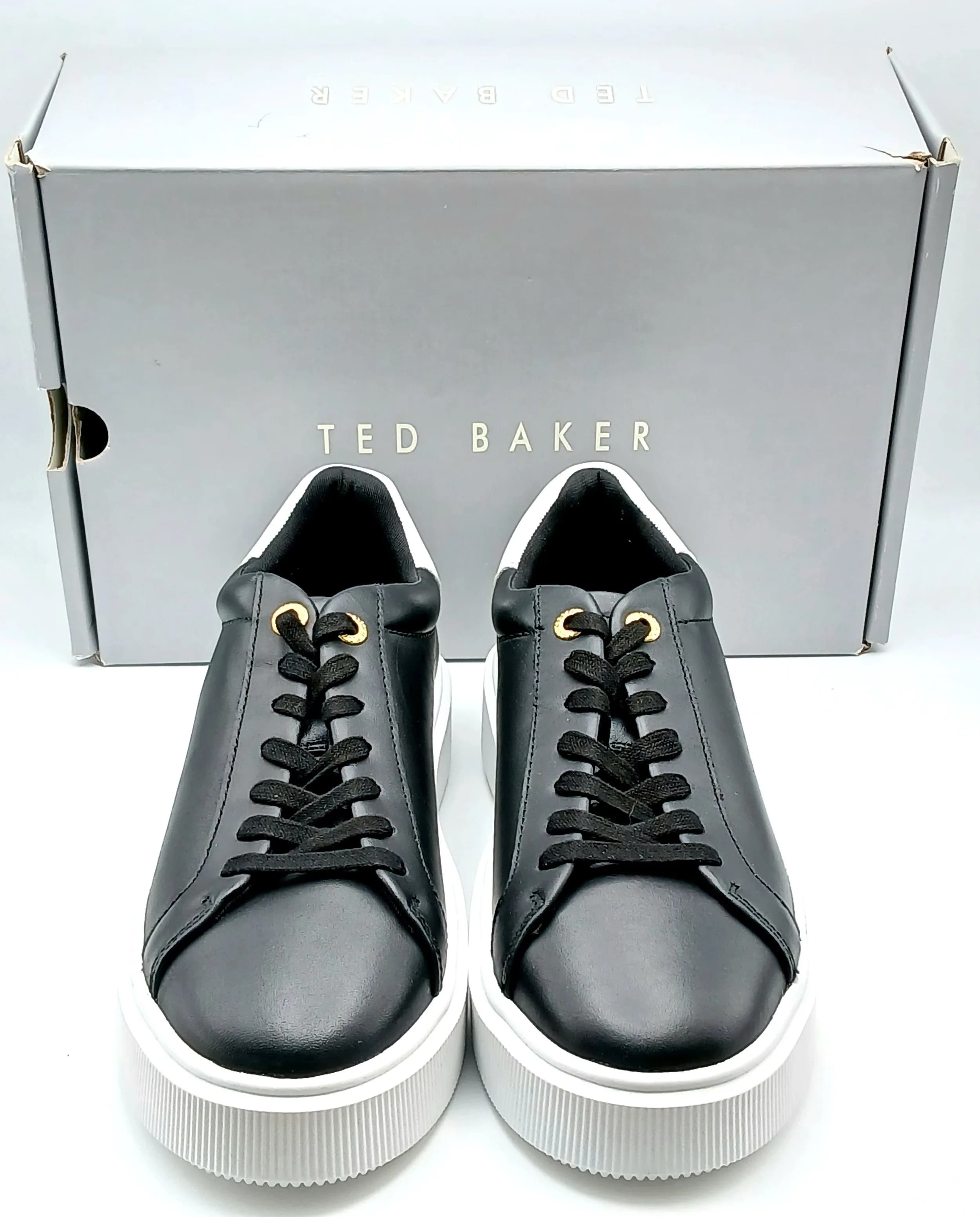 A pair of Ted Baker Lory trainers in black leather, platform heel. New in original box, Size UK7, US size 9.