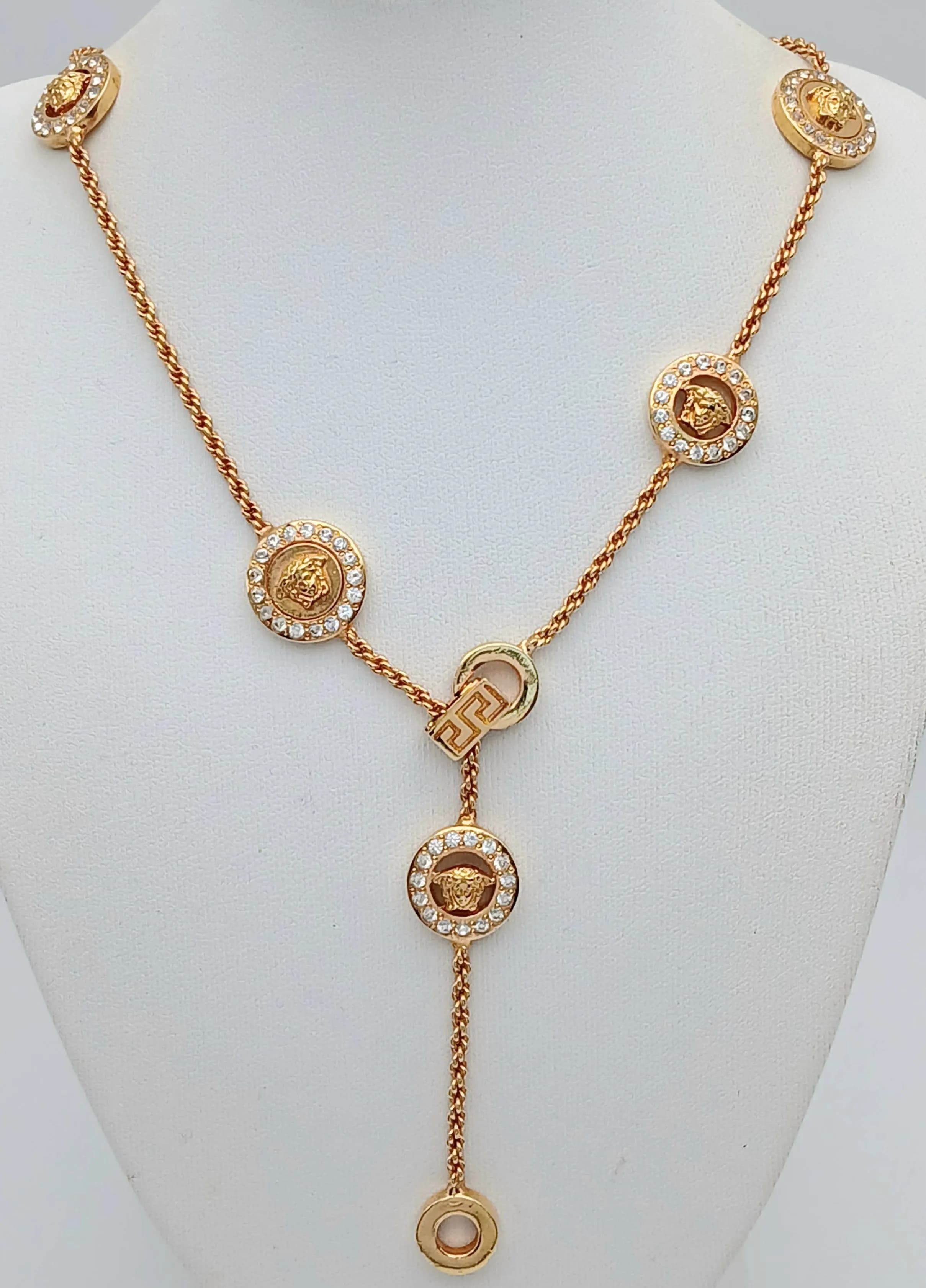 A Versace Gold Plated Necklace with Classic Versace Medallion Spacers. Adjustable length. 48cm. Original packaging. Ref: 029451.