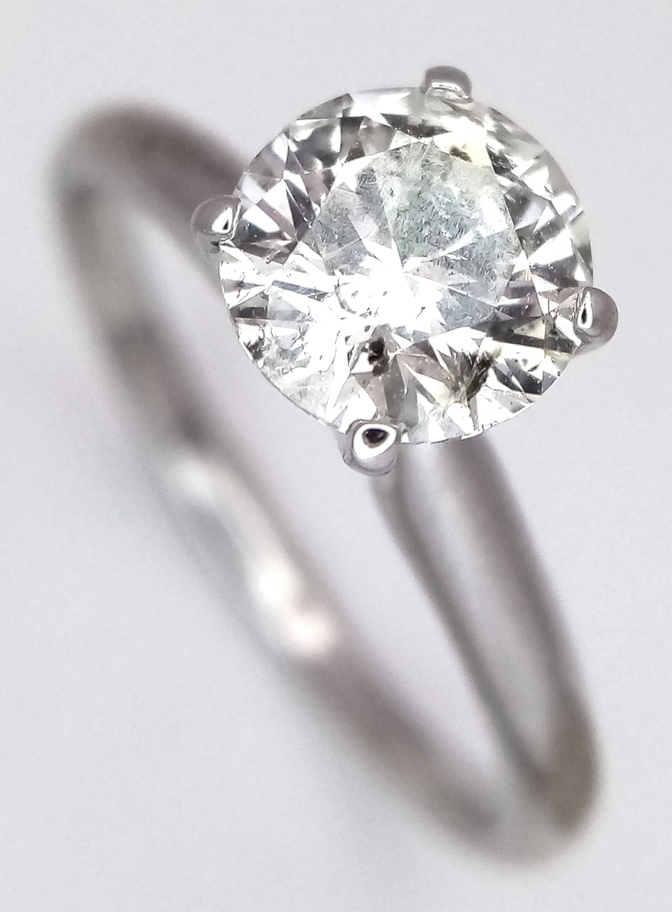 A 14K White Gold 1ct Diamond Solitaire Ring. Round brilliant cut 1ct diamond having J colour and SI2 clarity. Size L 1/2. 2.35g total weight. Ref: 026871.