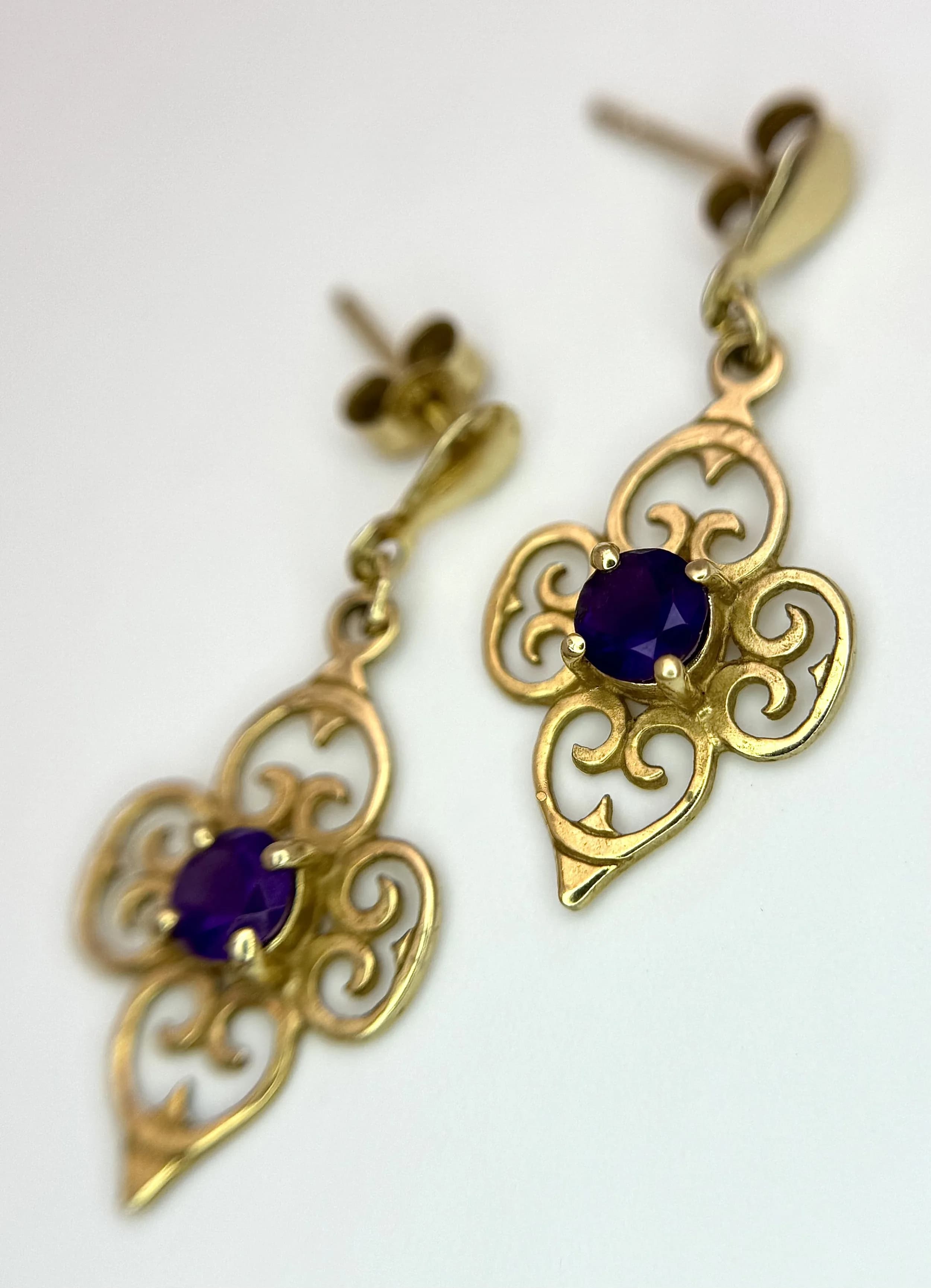 A Pair of Antique Style 9K Yellow Gold and Amethyst Petit Drop Earrings. 1.4g total weight. 2.5cm drop.