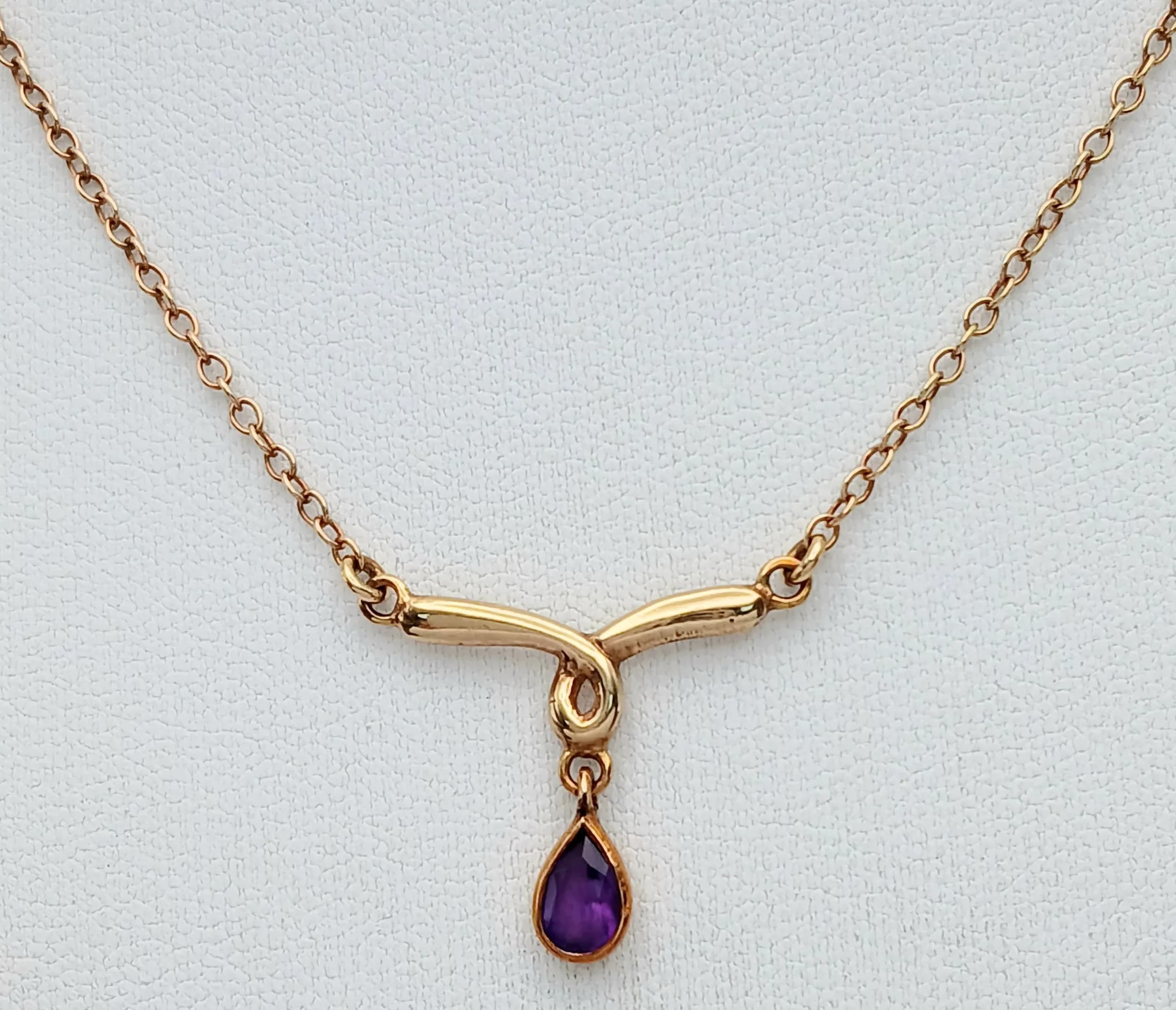 A 9K Yellow Gold Lavaliere Necklace with Amethyst Crossover Pendant. 42cm. 2.65g total weight.