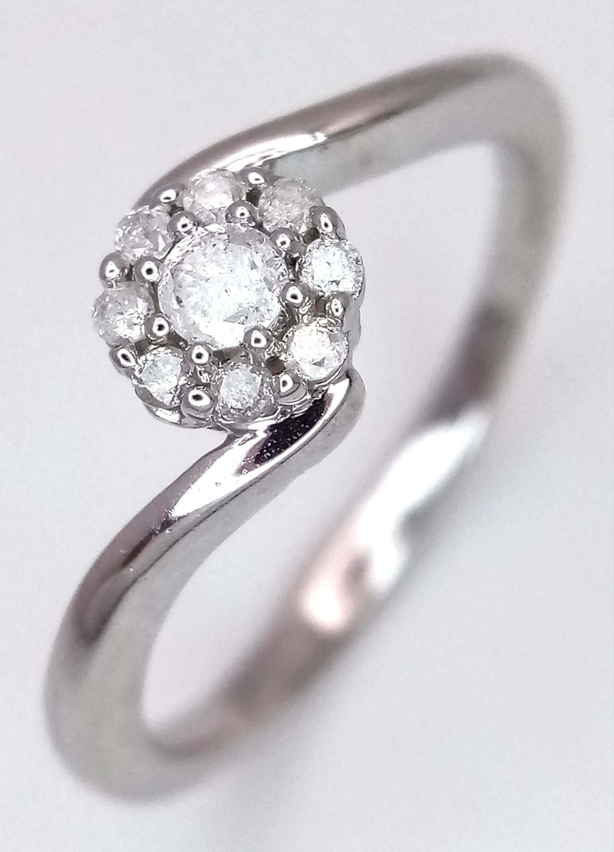 A 9K WHITE GOLD, DIAMOND SET, TWIST DESIGN, CLUSTER RING. 0.16CTW. 2.3G, SIZE M. SC 5013