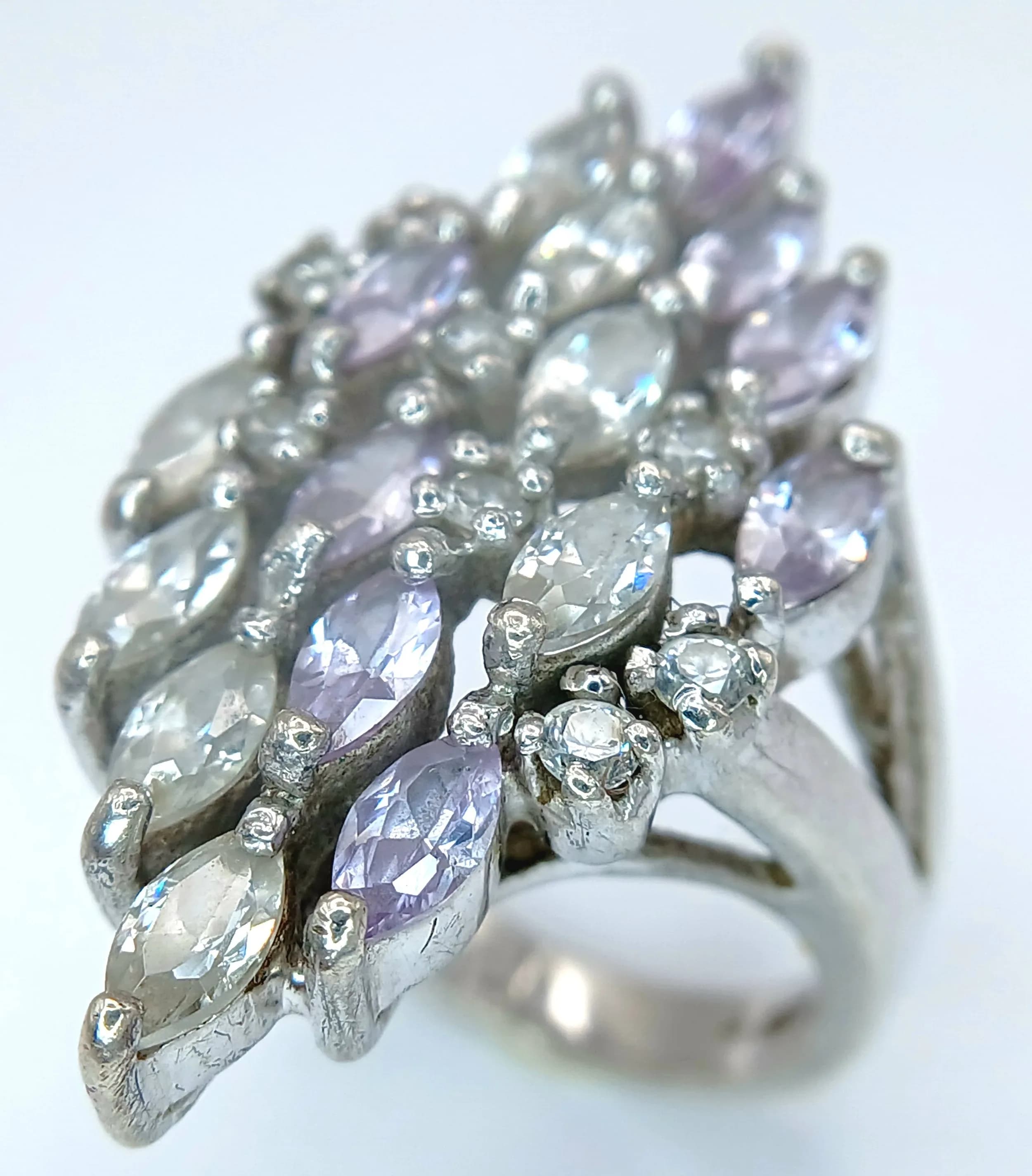A Vintage Sterling Silver Art Deco Inspired Purple and White Stone Cluster Ring. The Ring measures 3.5cm Length at the Crown and has a gross weight of 10 grams.