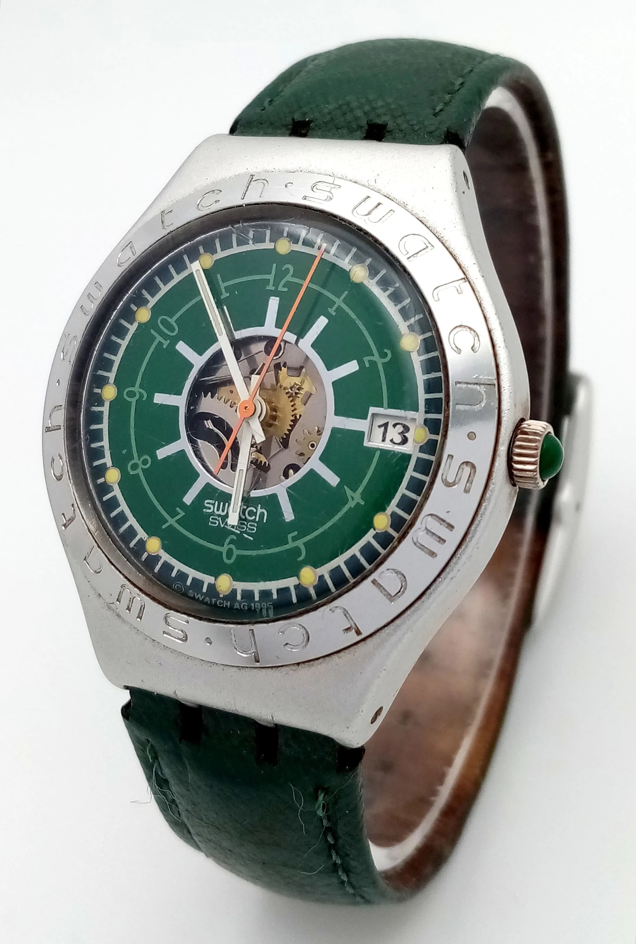 A SWATCH IRONY, IRISH WEEKEND, GREEN STRAP WATCH FROM 1995. PART SKELETON FRONT DIAL. ORIGINAL STRAP AND BUCKLE. IN FULL WORKING ORDER. NEW BATTERY FITTED RECENTLY. S/A 1702 - 2