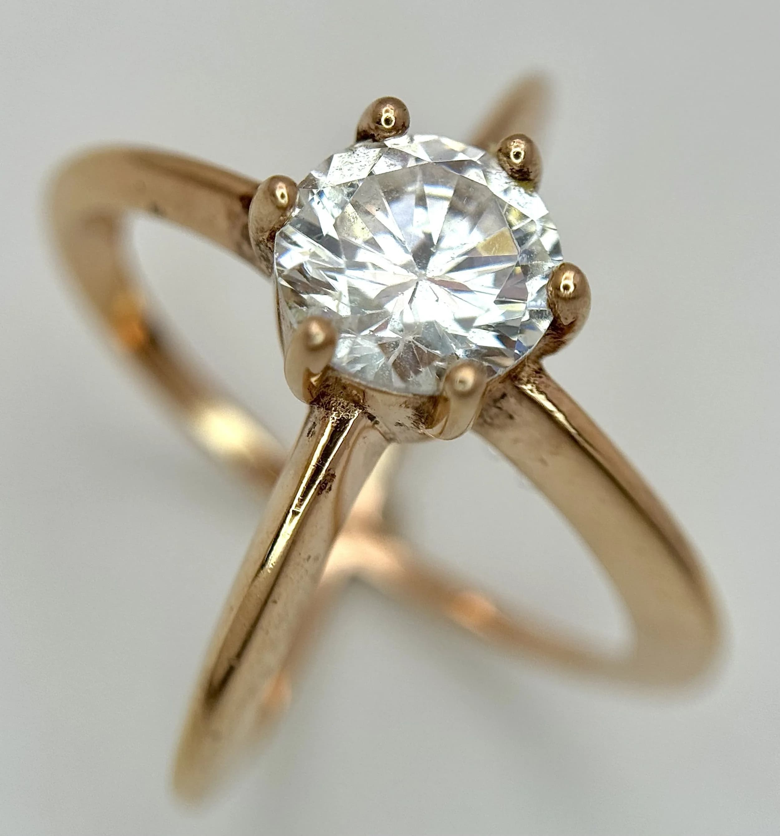 A Gold Gild Gilded Sterling Silver Lily Arkwright Annora Twist Solitaire Ring Size M1/2. The Ring is set with an 8mm Round Cut Diamonique Cubic Zirconia Solitaire. Diamonique being better quality CZ with Diamond appearance. Gross weight 5.45 grams.