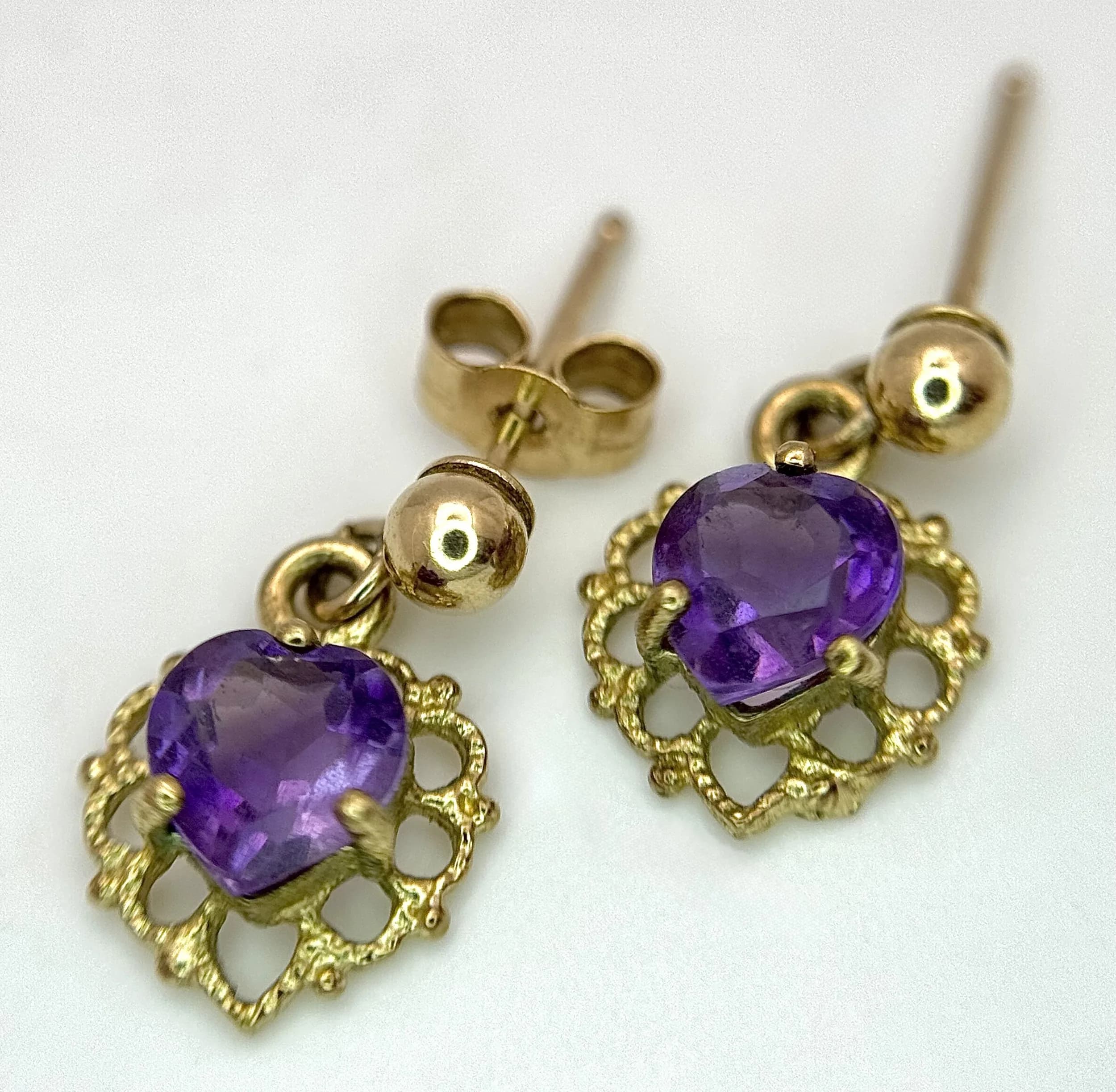 A Pair of 9K Yellow Gold and Amethyst Petit Drop Earrings. 0.9g total weight.