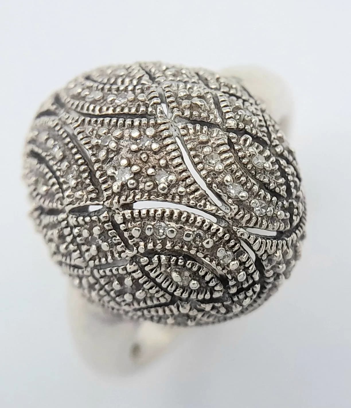 A Vintage Sterling Silver Art Deco Design Diamond Set Bombe Cocktail Ring. Size P. The Ring has a Dome shape Crown set with thirty round cut Diamonds, circa 0.15 ctw. The Ring weighs 5.62 grams.