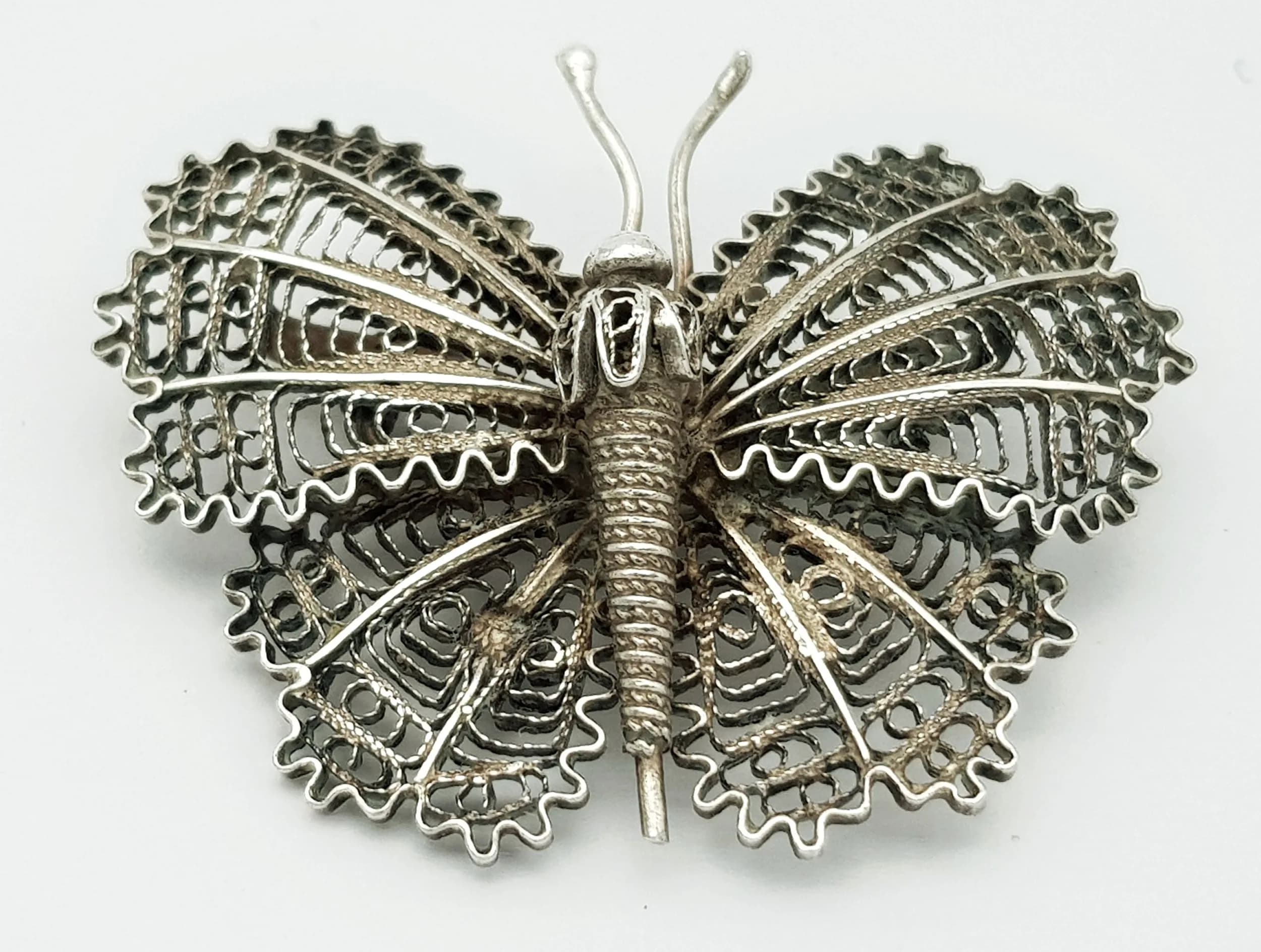 A Vintage Silver Filigree Butterfly Brooch. Features an intricately detailed butterfly with openwork filigree wings and secure pin fastening. The brooch measures 4cm x 4cm. Total weight 6.20 grams.