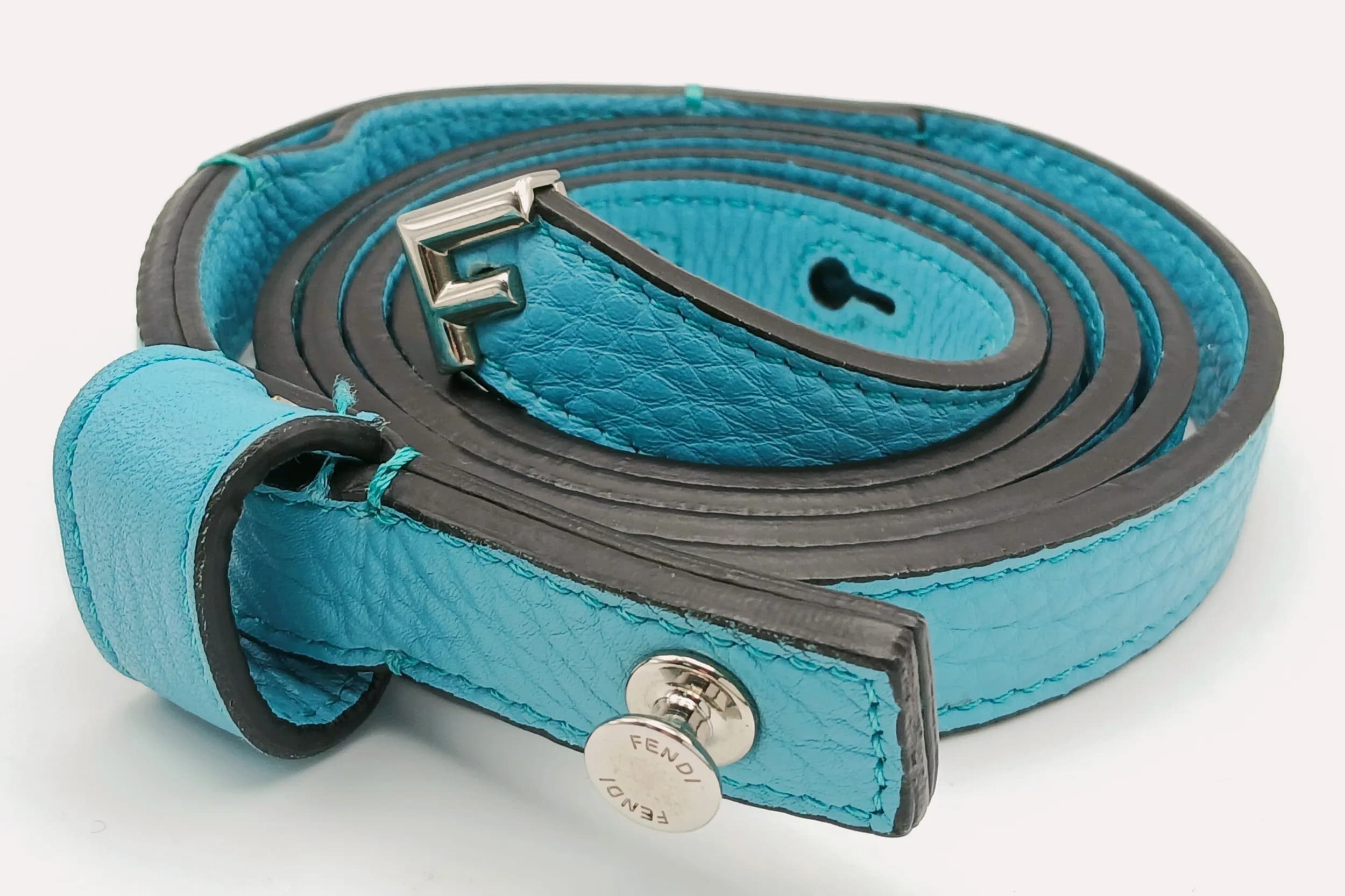 A Fendi Turquoise Blue Leather Belt. Turquoise Blue leather with silver-toned hardware and adjustable buckle fastening. Approx. 129cm total length. Some signs of use to the leather and scratches to the hardware. Please see photos or request a condition report. Ref: 29424.