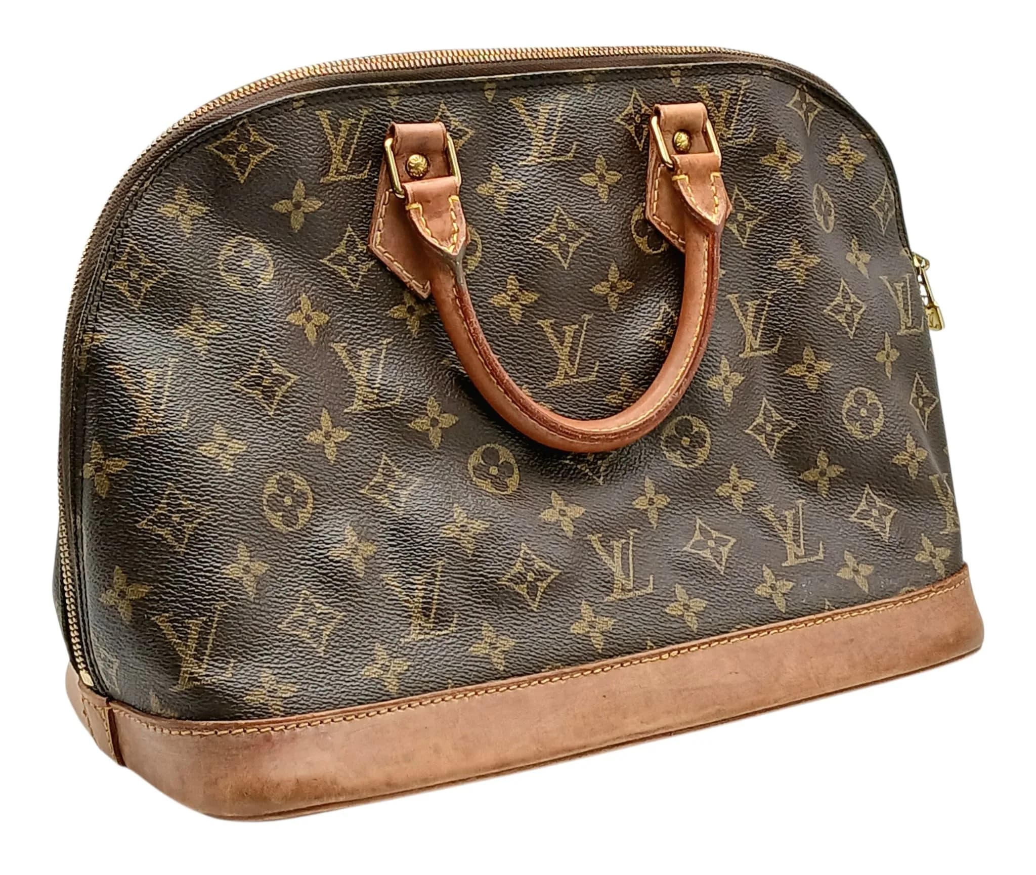 A Brown Louis Vuitton Monogram Alma PM Handbag. Brown Monogram coated canvas exterior with rolled top handles, zipped top closure and gold-toned hardware. Brown textile interior with one main compartment and a slip pocket. Approx. 38cm length x 21cm height x 13cm depth. Some signs of wear, patina, scratches, stains and marks to the leather. Comes with a dust cover. Please see photos or request a condition report. Ref: 29327.
