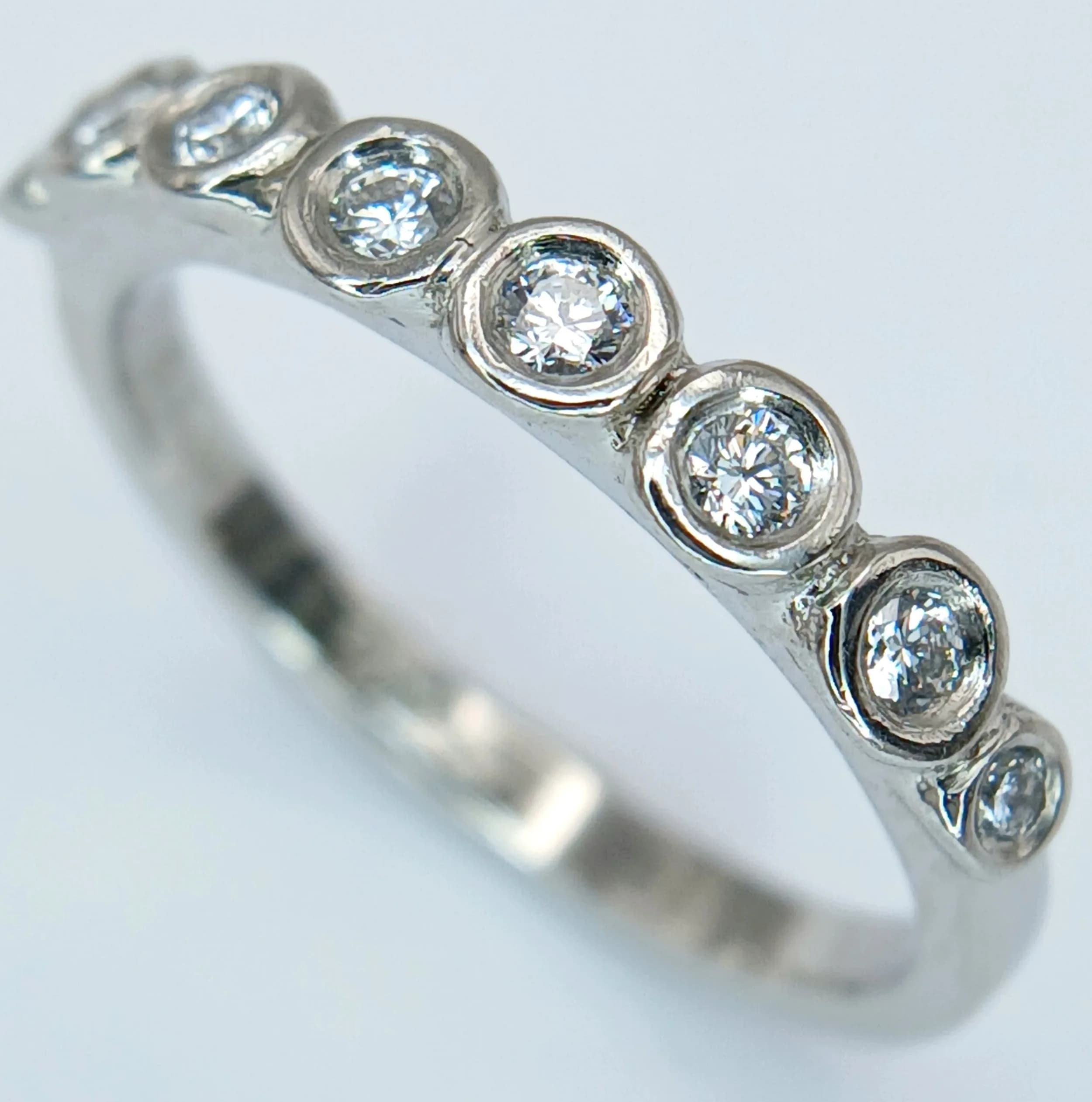 A PLATINUM, DIAMOND SET, 8 STONE RING. 0.15CTW. 3.1G, SIZE I. SC 6057